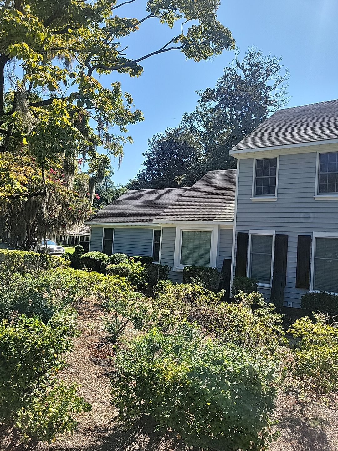 Two-Story Roof Replacement in Progress in Wilmington, NC by RGR Construction and Roofing, LLC