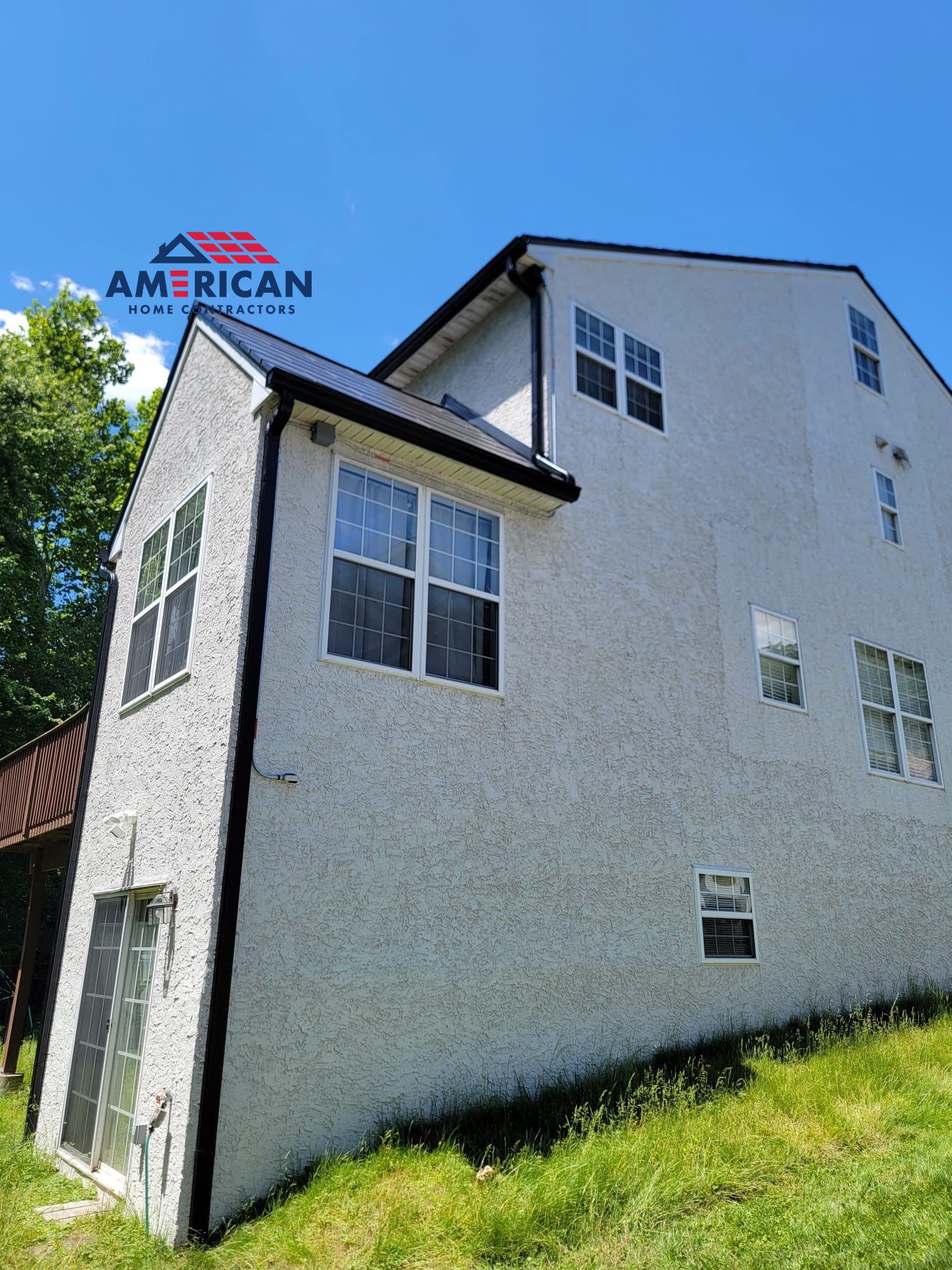 Tesla Solar Roof, Powerwall, and Black Gutters by American Home Contractors