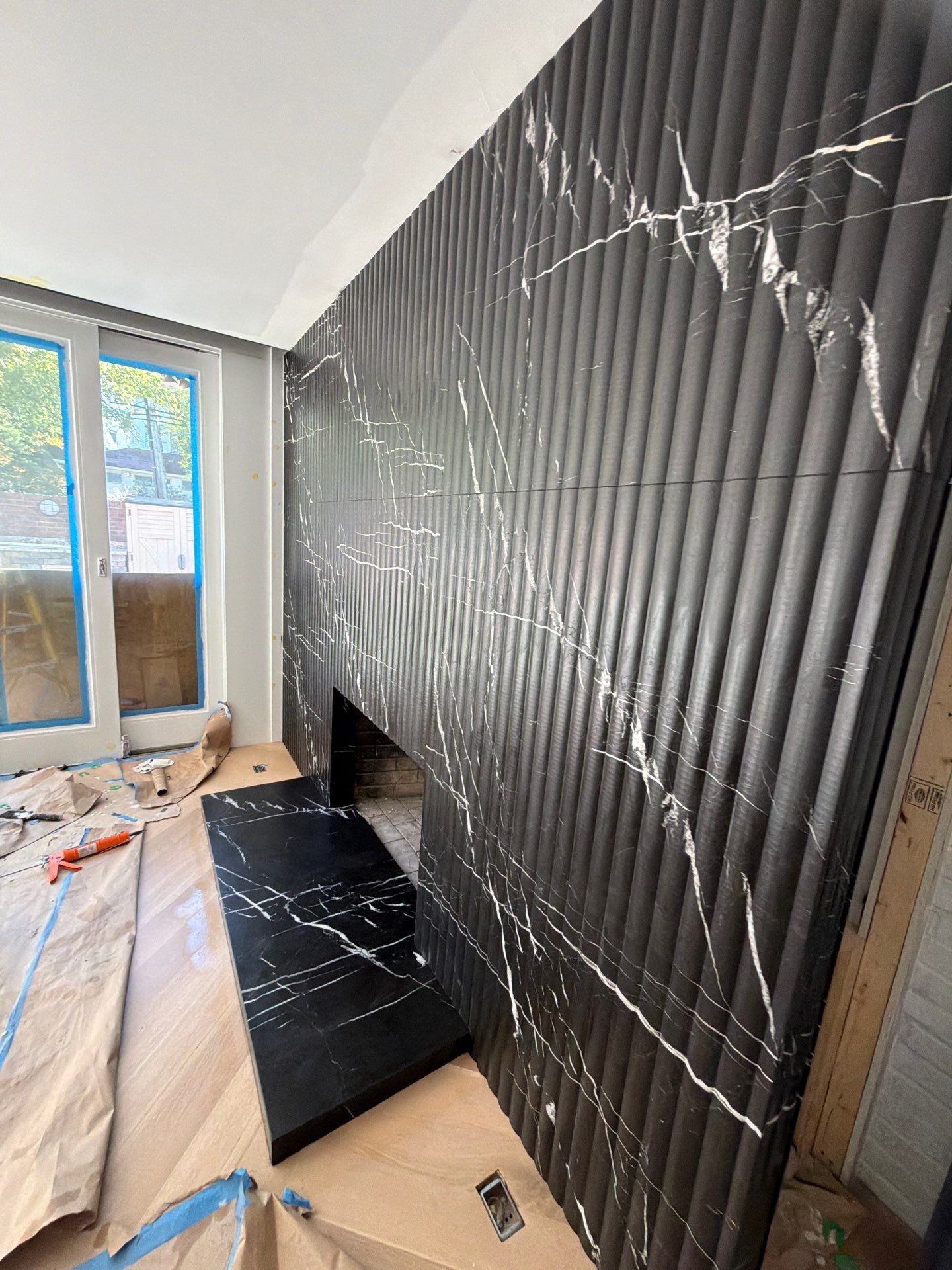 Full-Height Fluted Marble Fireplace Wall by NC Stone And Tiles