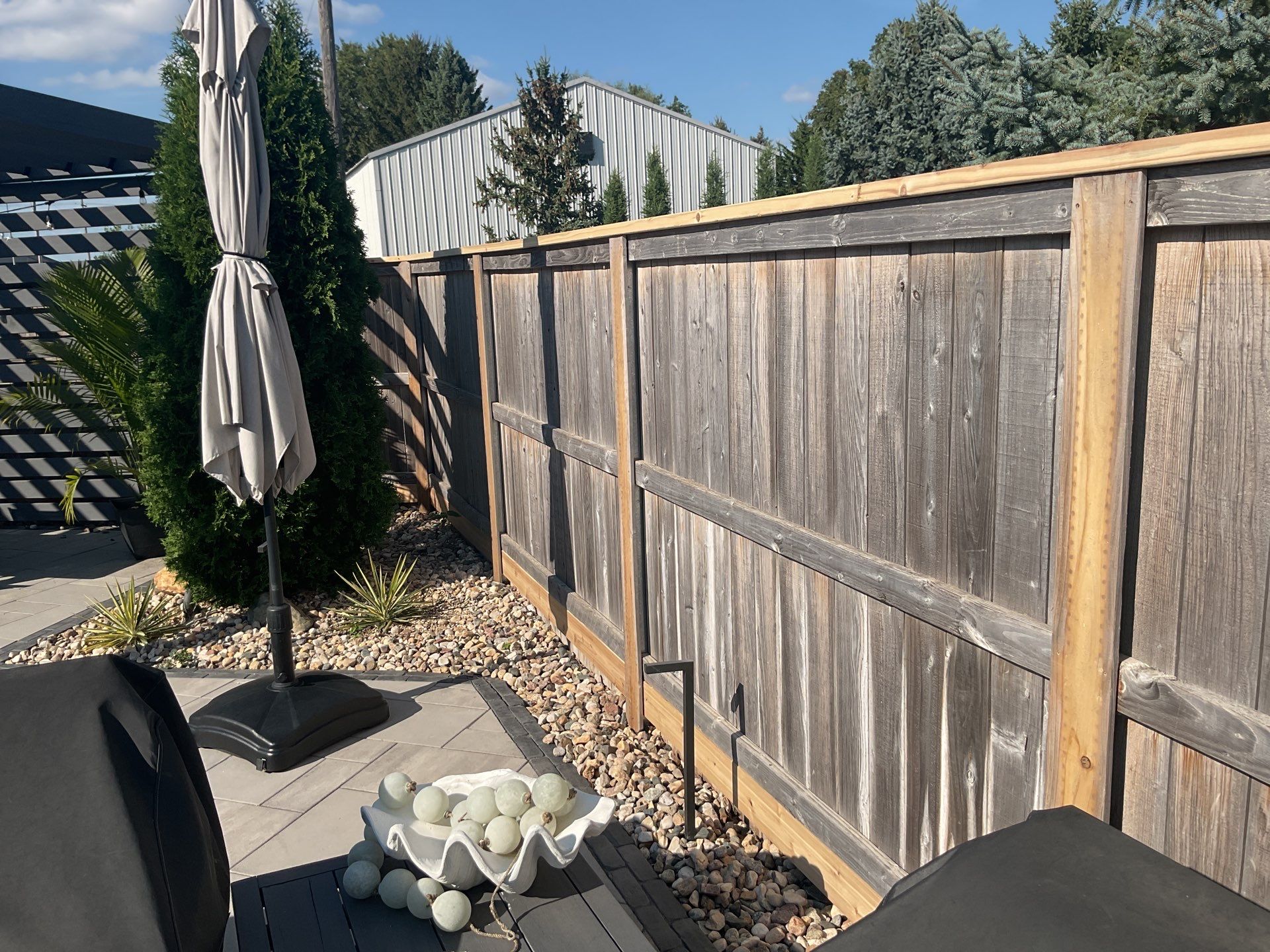 Custom Privacy Fence and Paver Patio Installation in Sioux Falls by Select Painting, Coatings & Garage Cabinets
