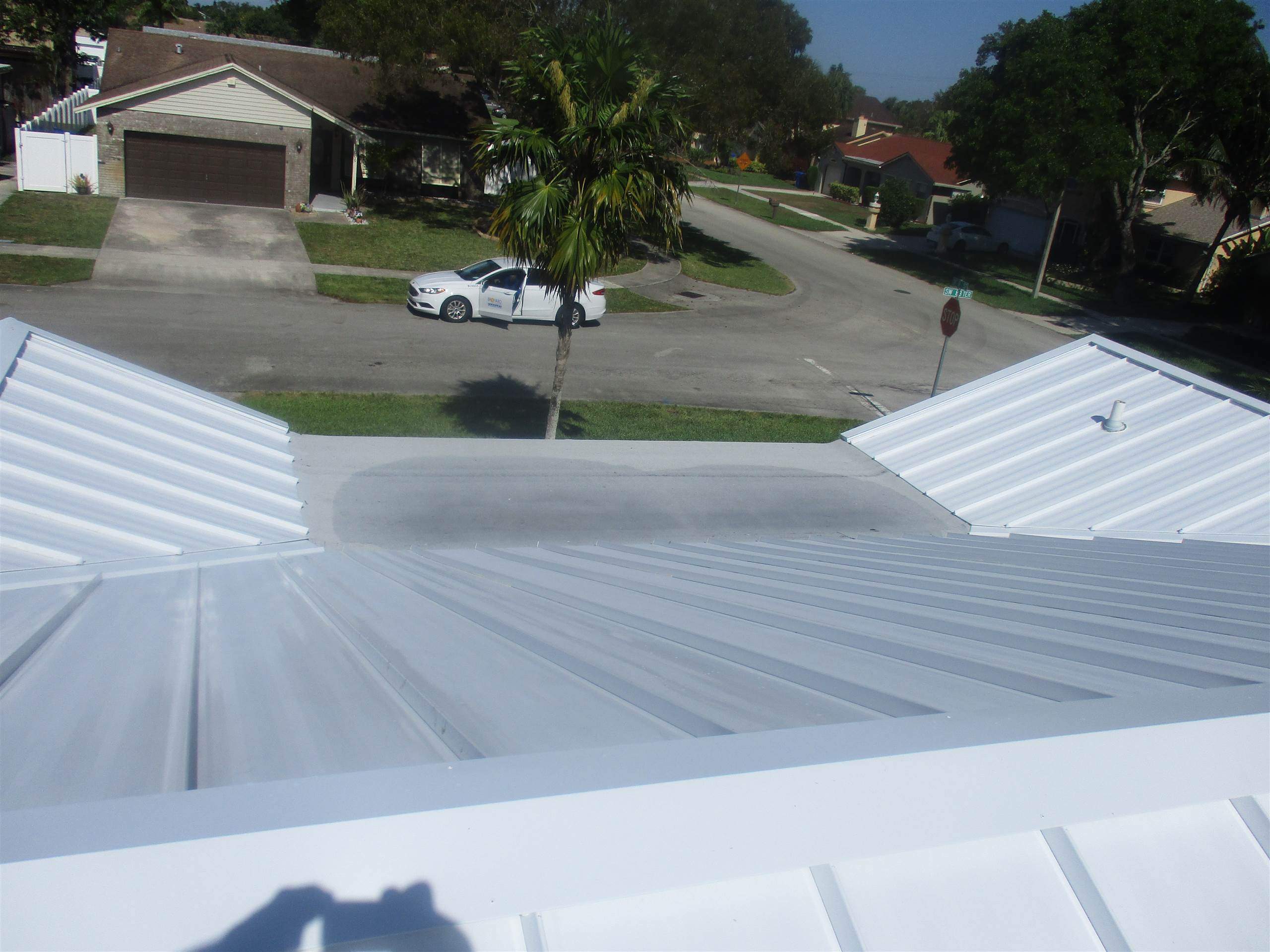 Standing Seam Metal & Flat Re-Roof using 1.5" Nail Strip 24ga Solar White Kynar Coated Standing Seam Metal Panels by Morton Roofing, Inc.