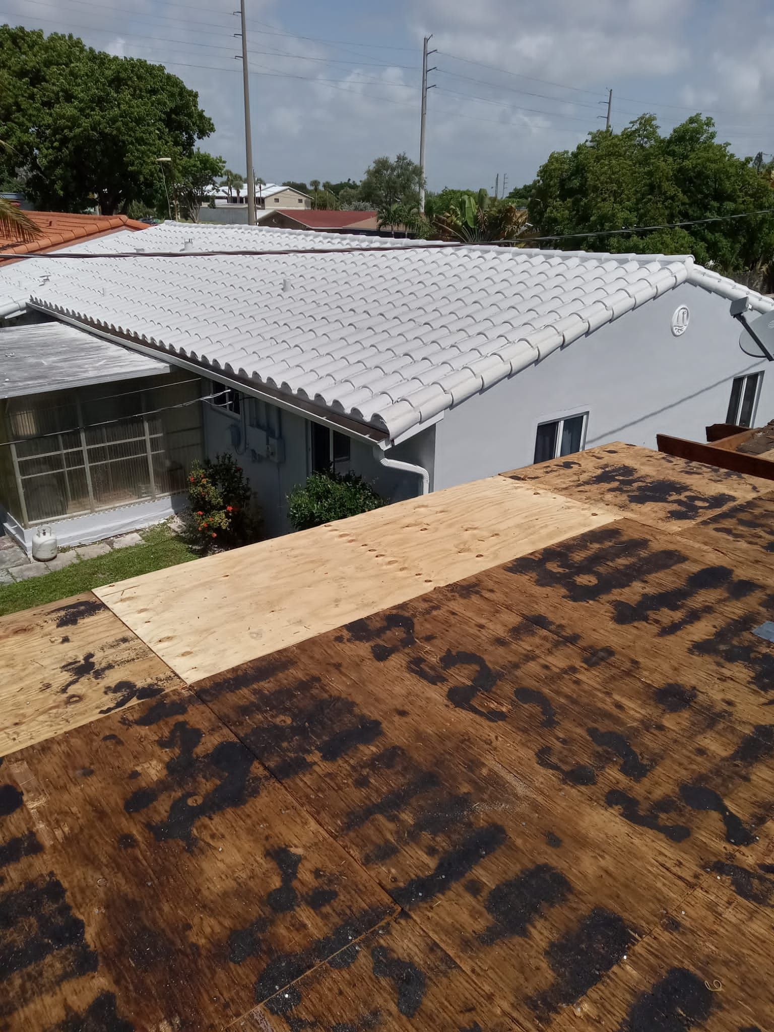 Standing Seam Metal & Flat Re-Roof using 1.5" Nail Strip 24ga Black Matte Kynar Coated Standing Seam Metal Panels by Morton Roofing, Inc.