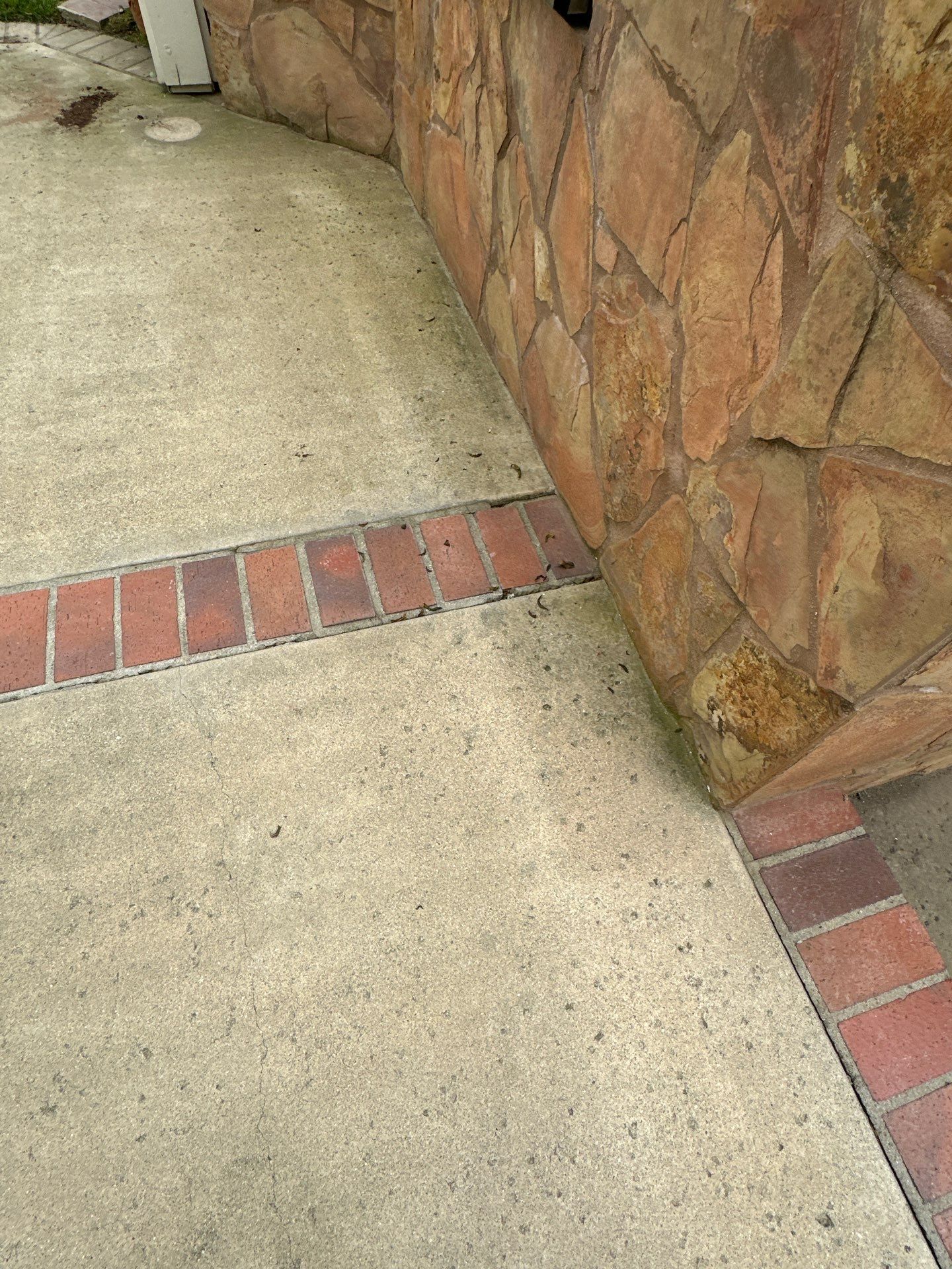 Surface cleaning pressure washing in Orange County on patio, walkways, and driveway by Property Cleaning Experts, LLC