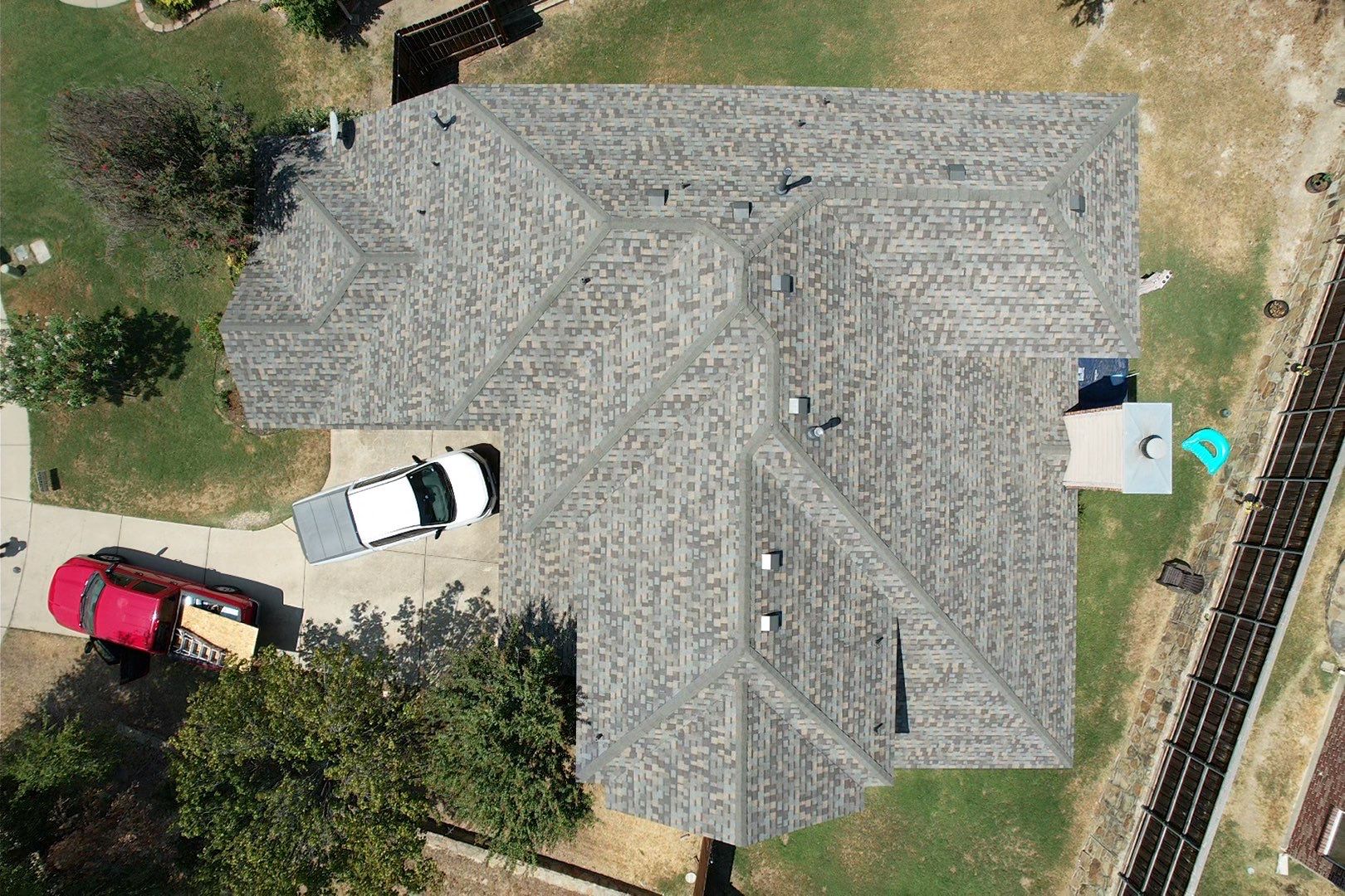 Red brick/white stone with IKO Cornerstone by Tejas Roofworks + Restoration