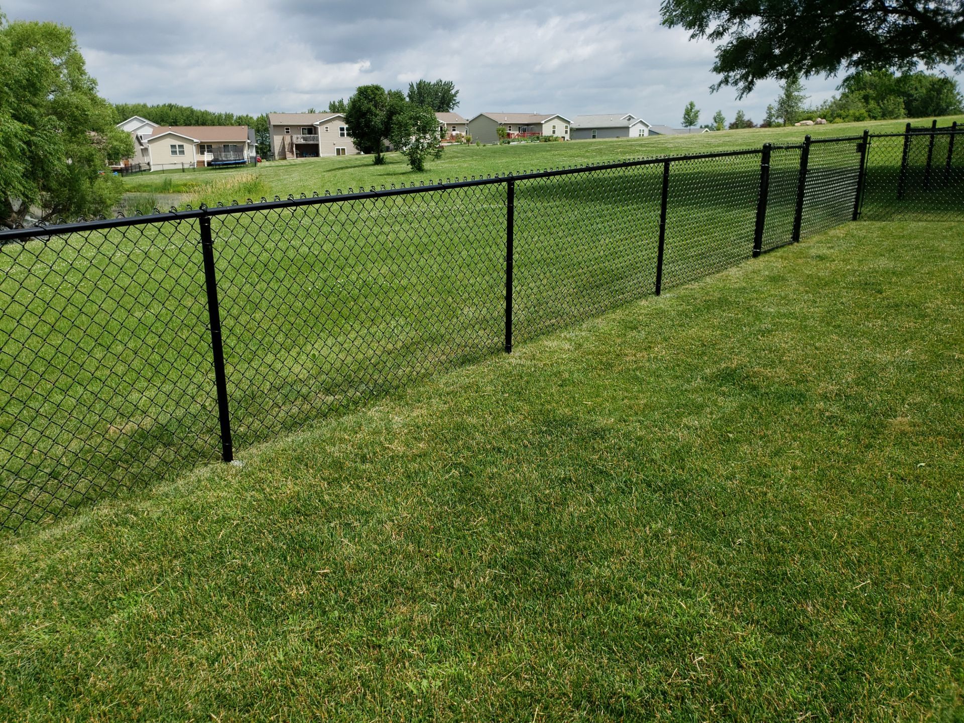 Black Vinyl Chain Link Perimeter Fence Installation in Waterloo by Perfect Picket Fence and Stain