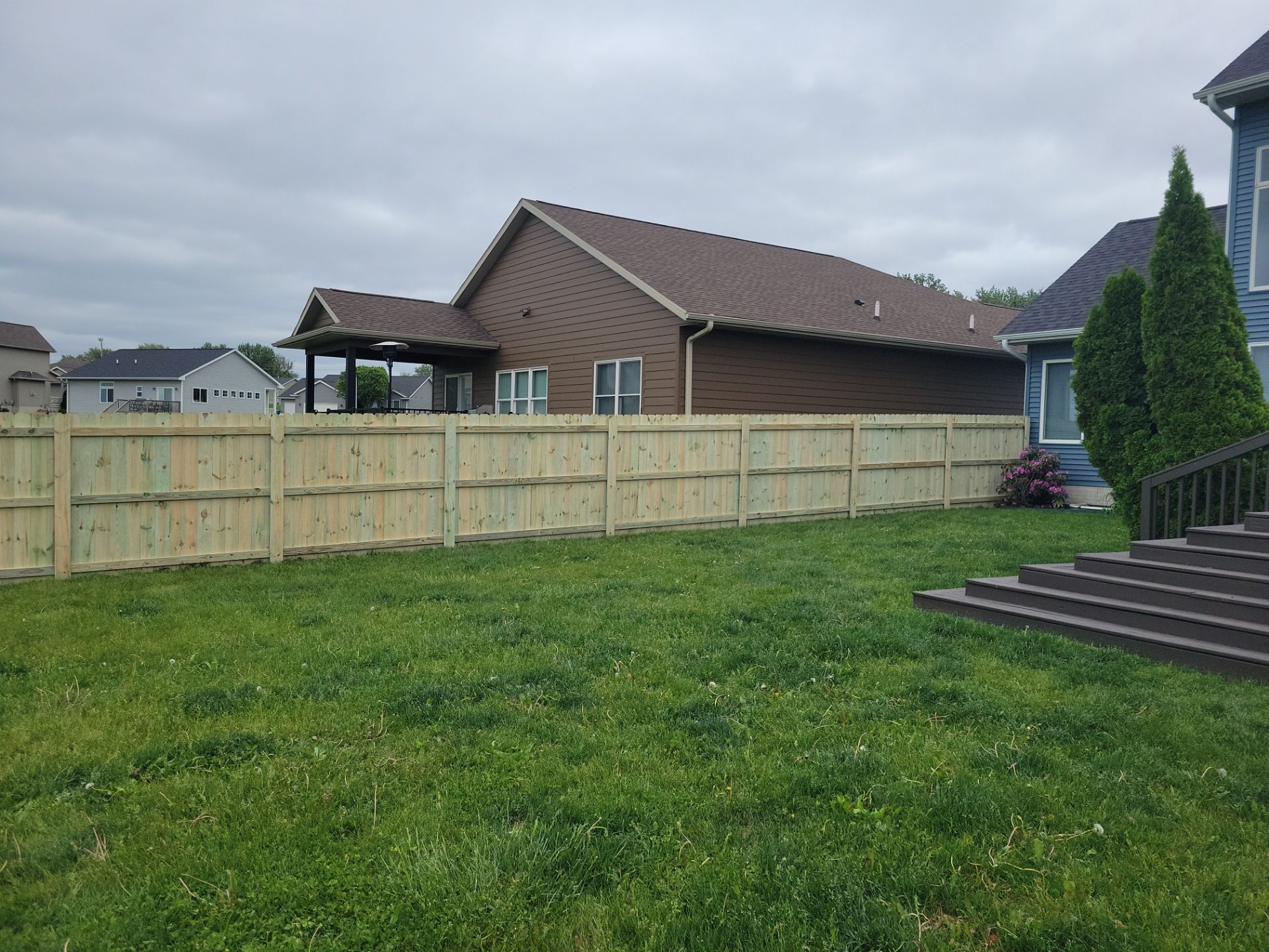 Pressure-Treated Wood Privacy Fence Installation in Waterloo by Perfect Picket Fence and Stain