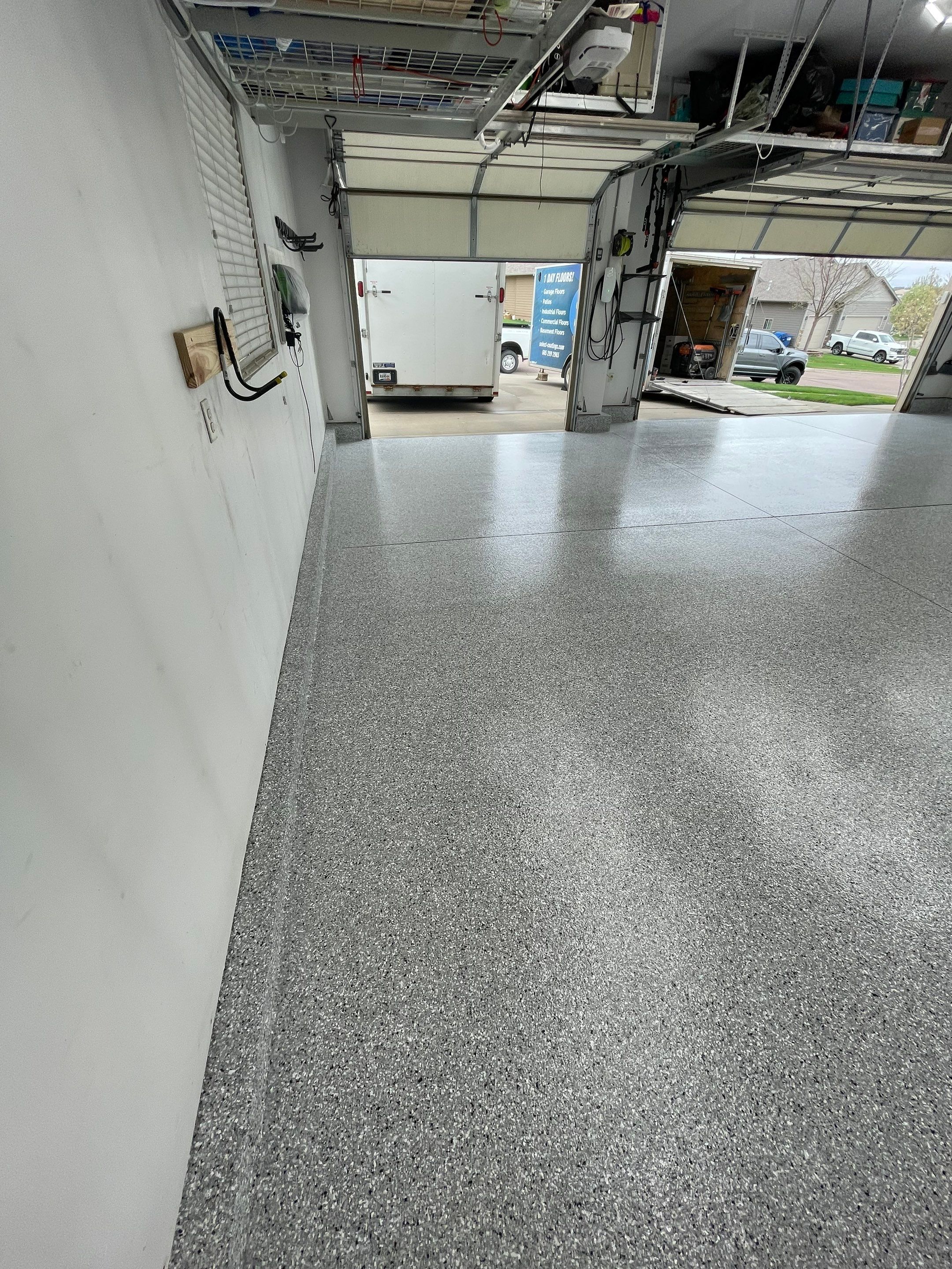 Feather Gray Epoxy Floor Coating Installation in Sioux Falls by Select Painting, Coatings & Garage Cabinets