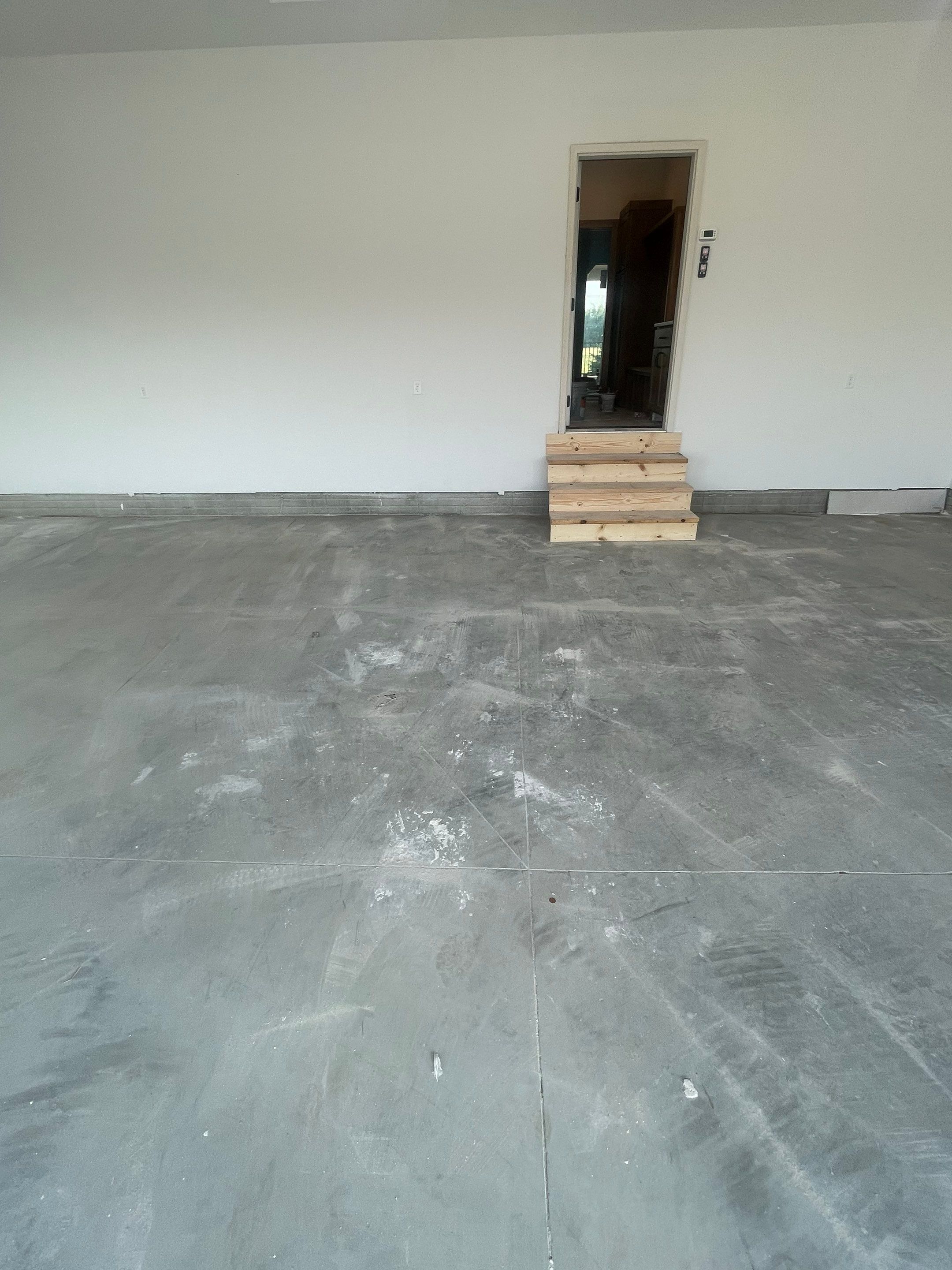 Grey Speckled Garage Floor Coating in Sioux Falls by Select Painting, Coatings & Garage Cabinets