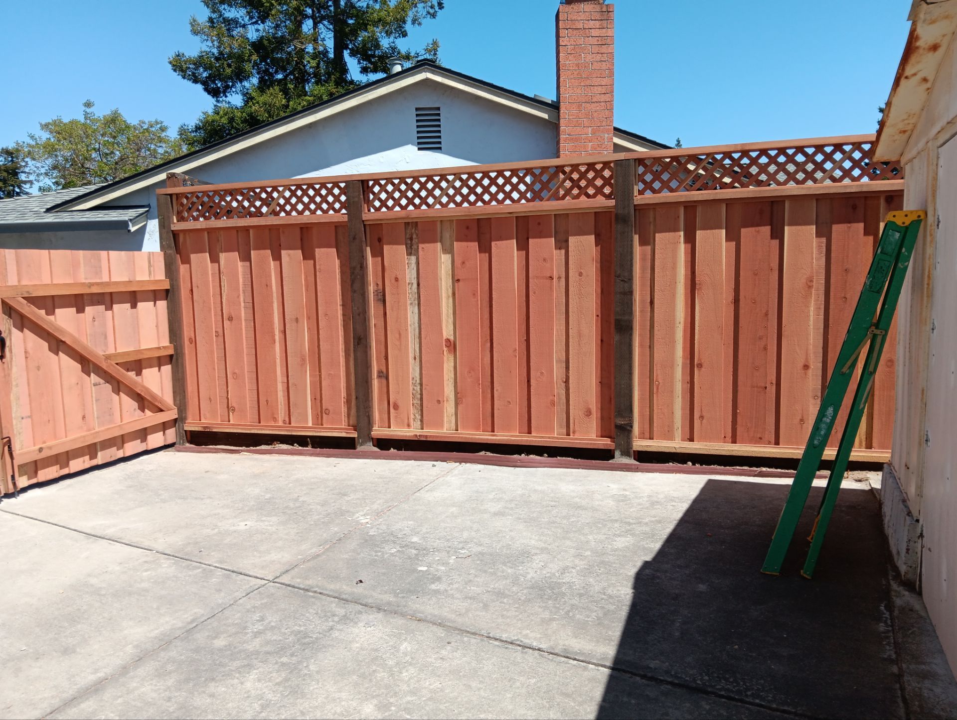 Board on Board with 1' Triple Lattice - 8' / 6' High by Fremont Fence Inc