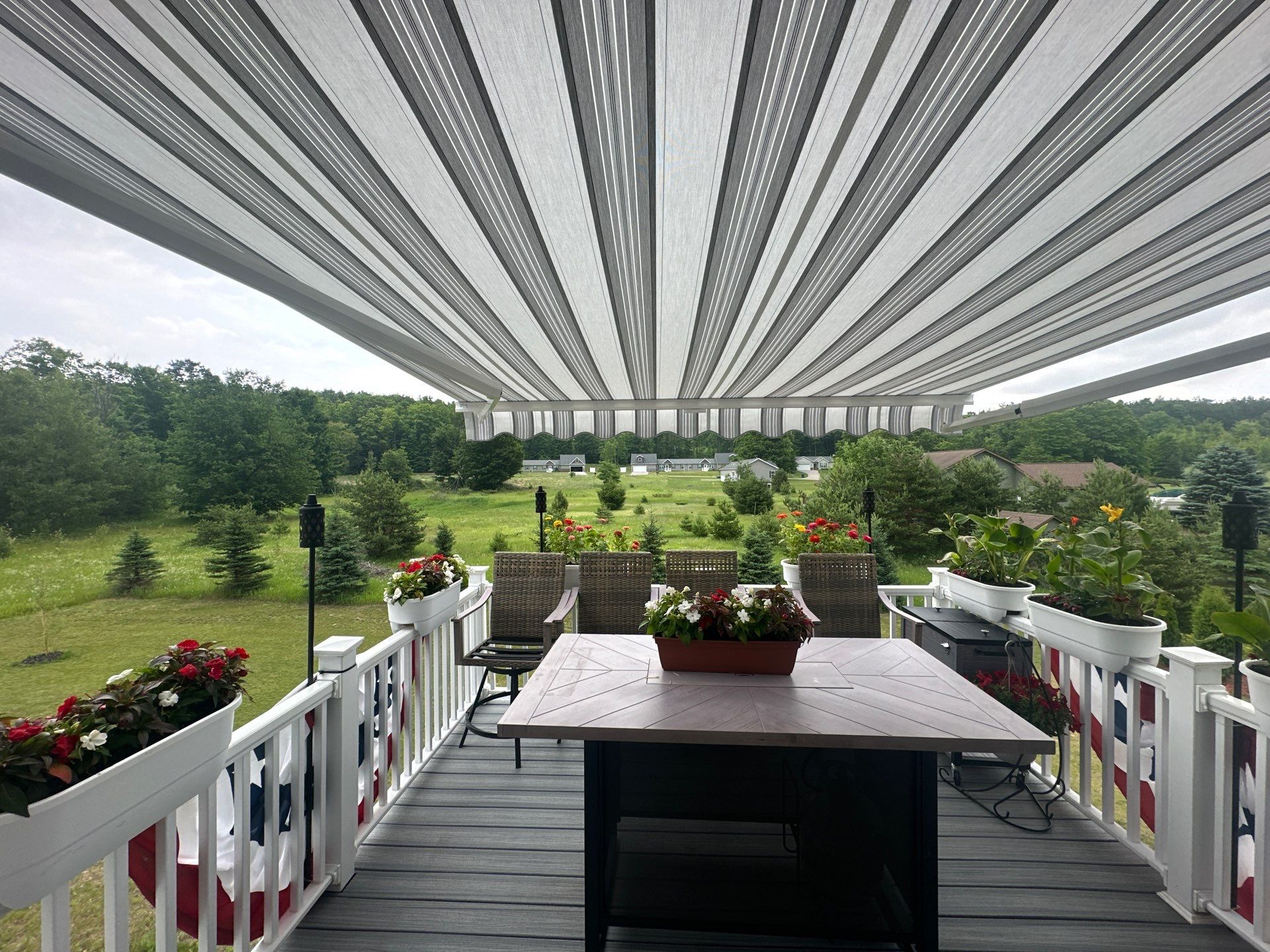 Sunesta Retractable Awning Installation Over Petoskey Home Deck by Rainbow Seamless Systems