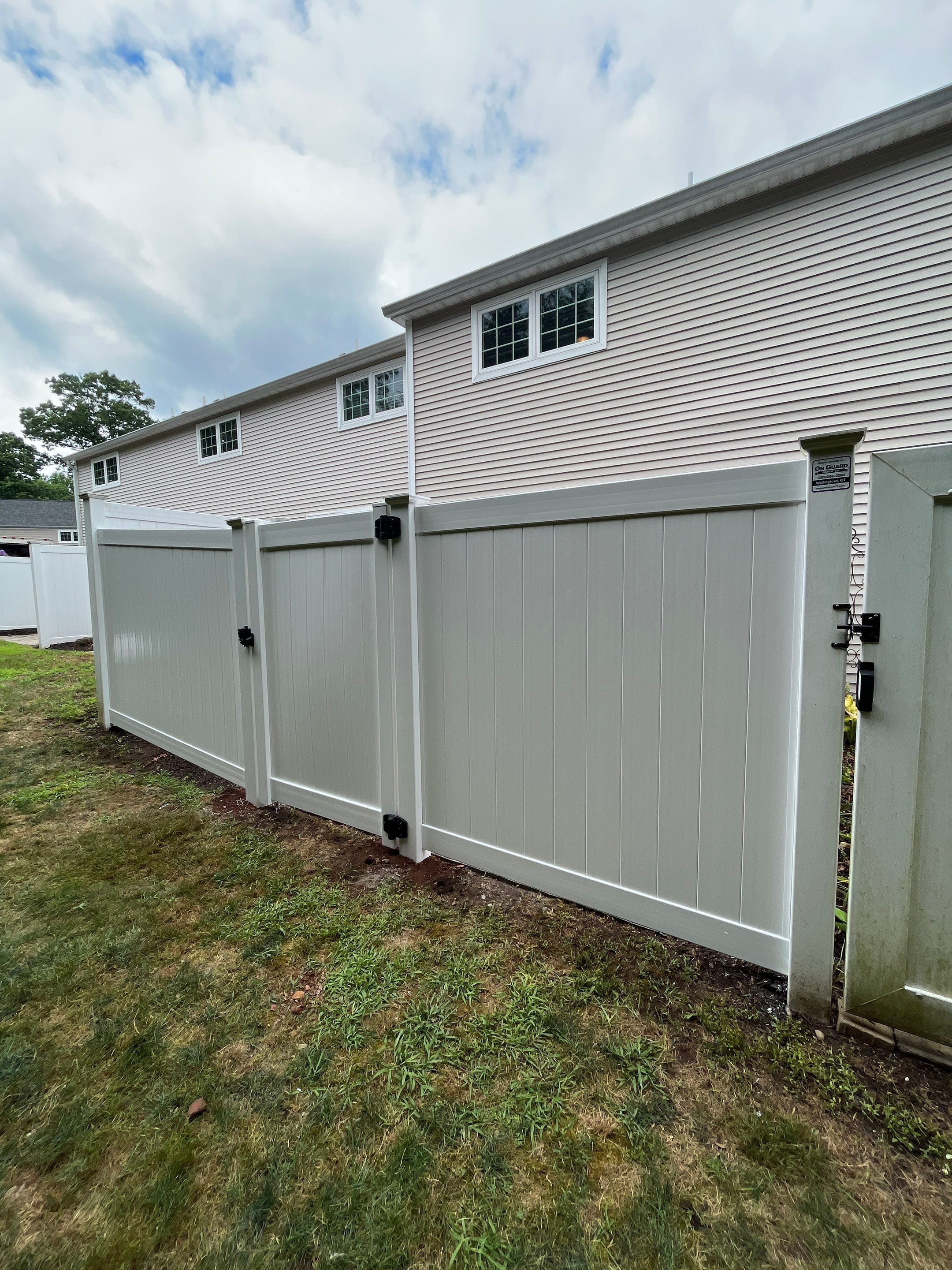 Vinyl privacy fence and matching gate  by DiGiorgi Roofing and Siding Inc