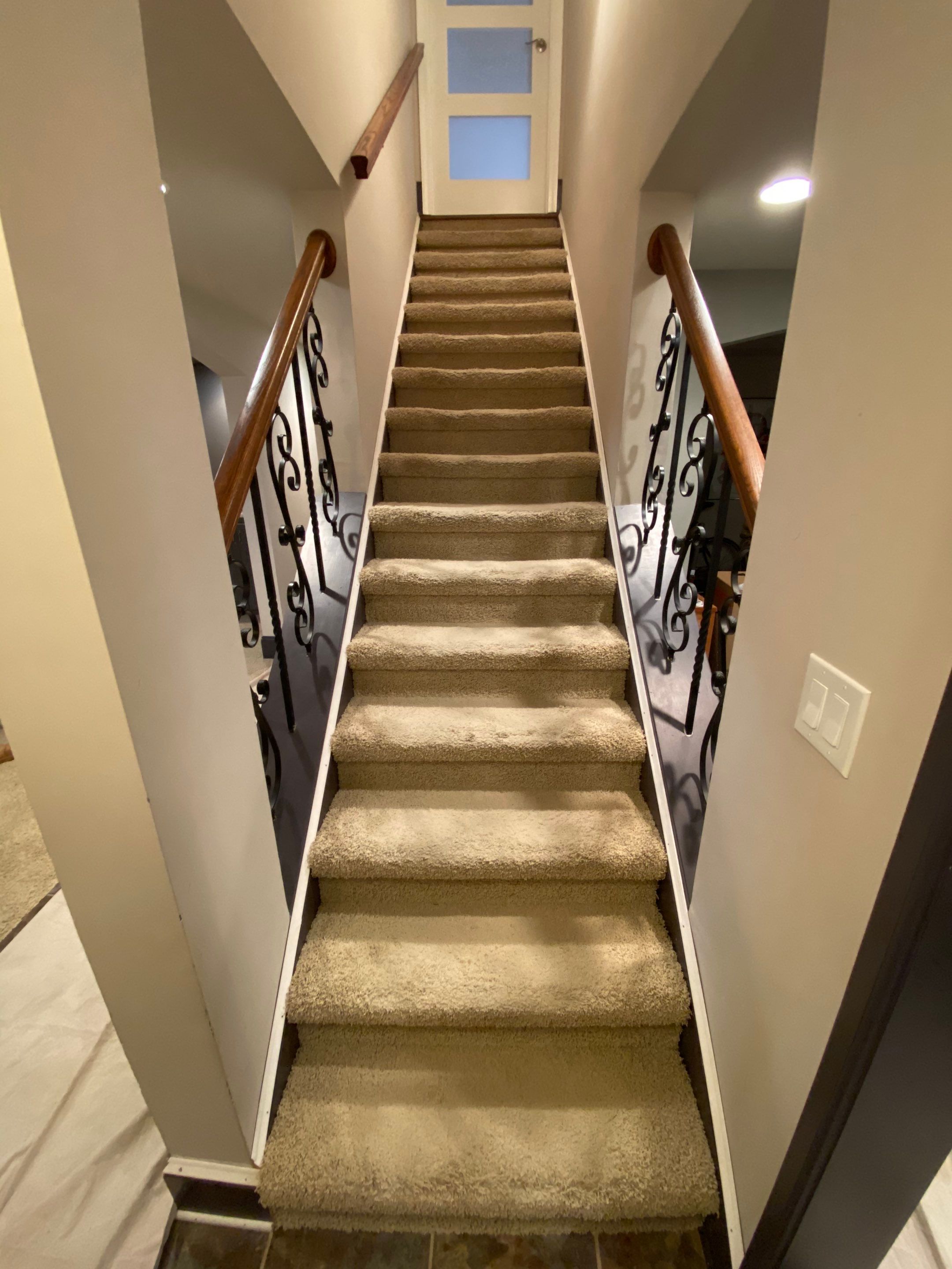 Finished Basement Renovation with Custom Shiplap and Modernized Wood Railings by Swift Home Renovations 