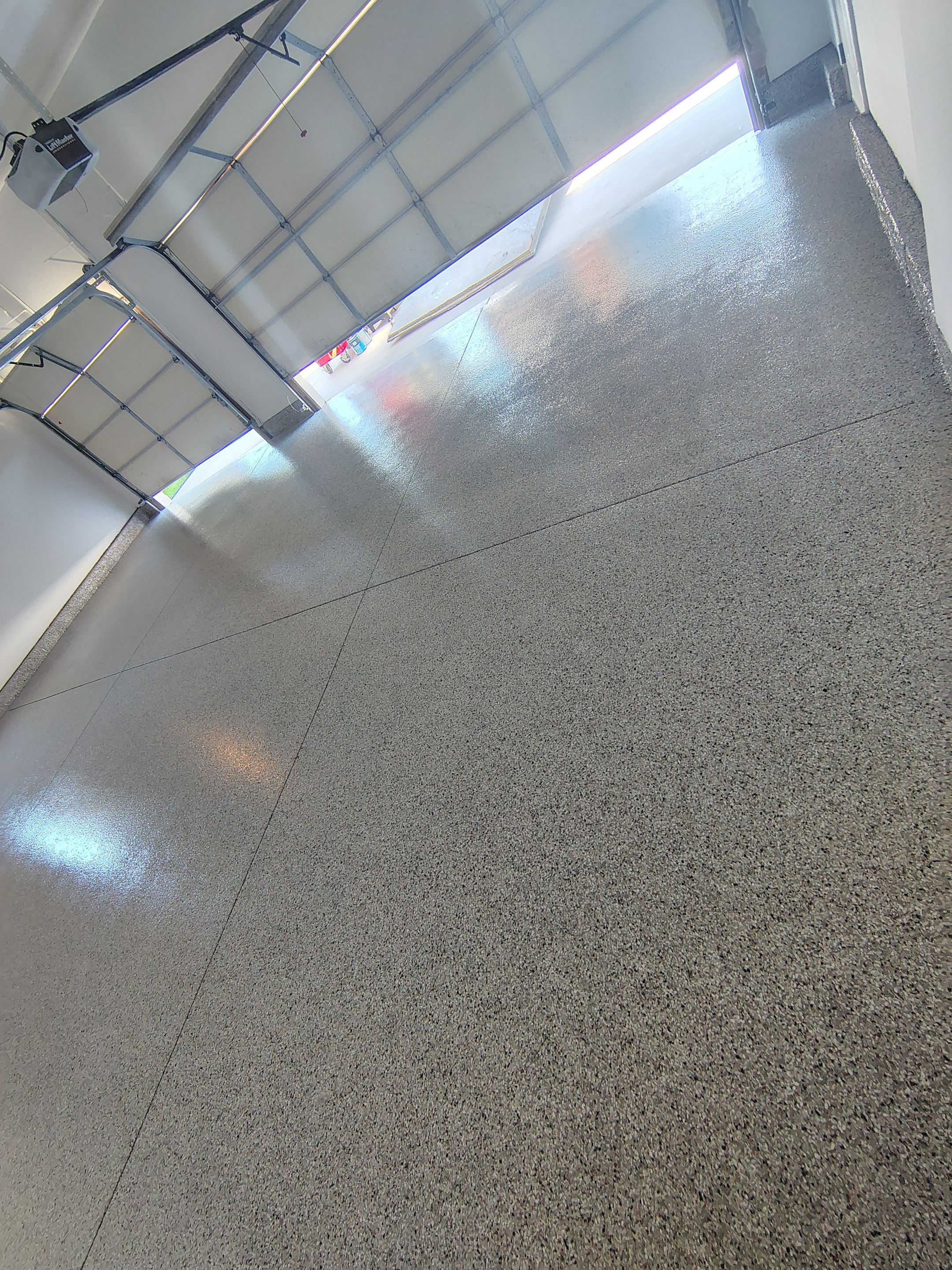 Custom Grey Speckled Epoxy Floor Coating for Sioux Falls Garage by Select Painting, Coatings & Garage Cabinets