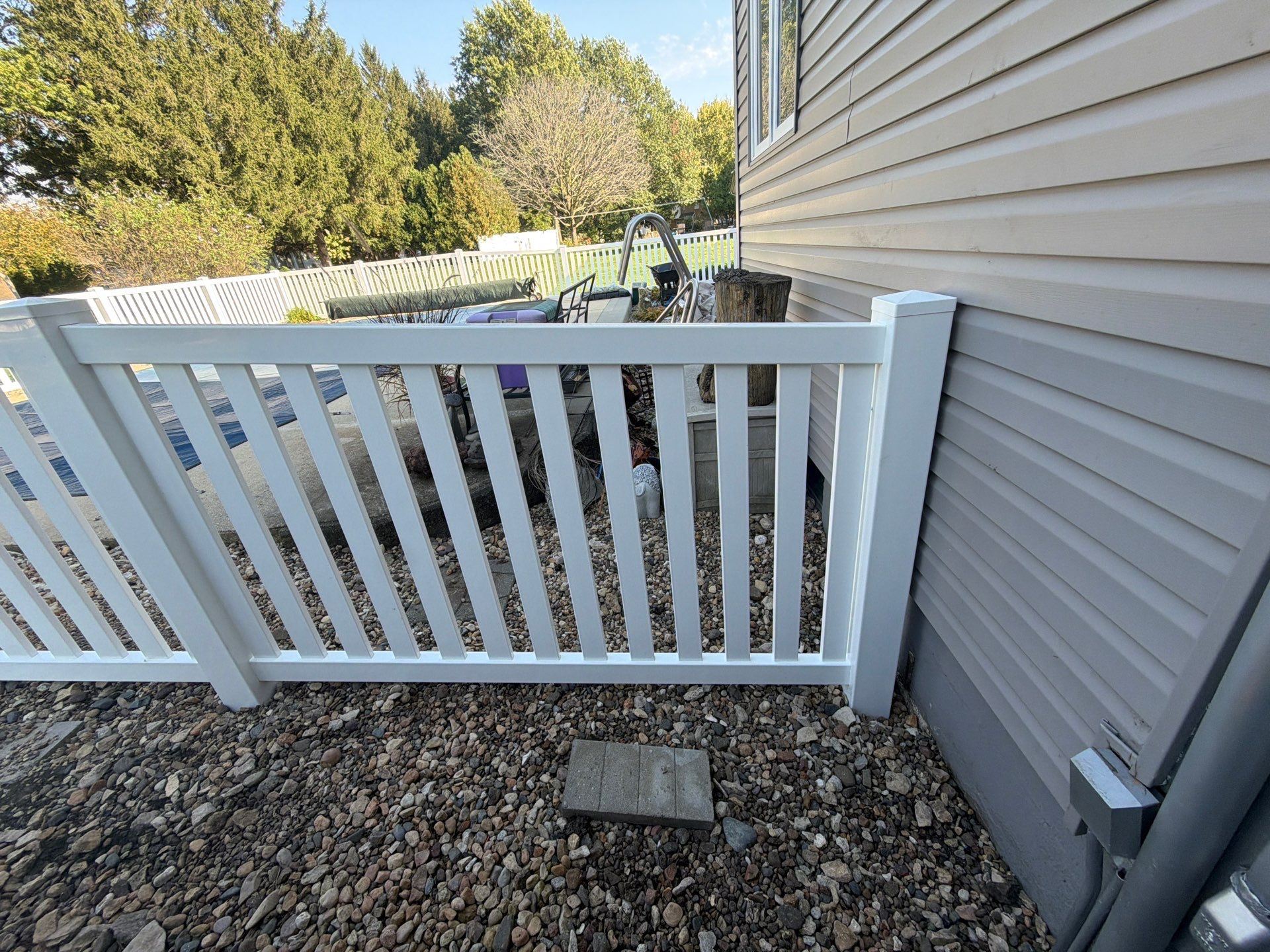 White Vinyl Picket Pool Fence Installation in Waterloo, Iowa by Perfect Picket Fence and Stain