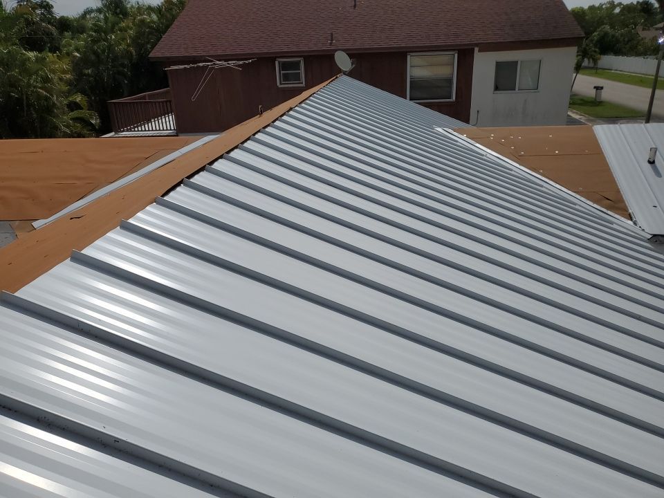 Residential Roofing Installation using 1.5" Nail Strip 24ga Solar White Kynar Coated Standing Seam Metal Panels by Morton Roofing, Inc.