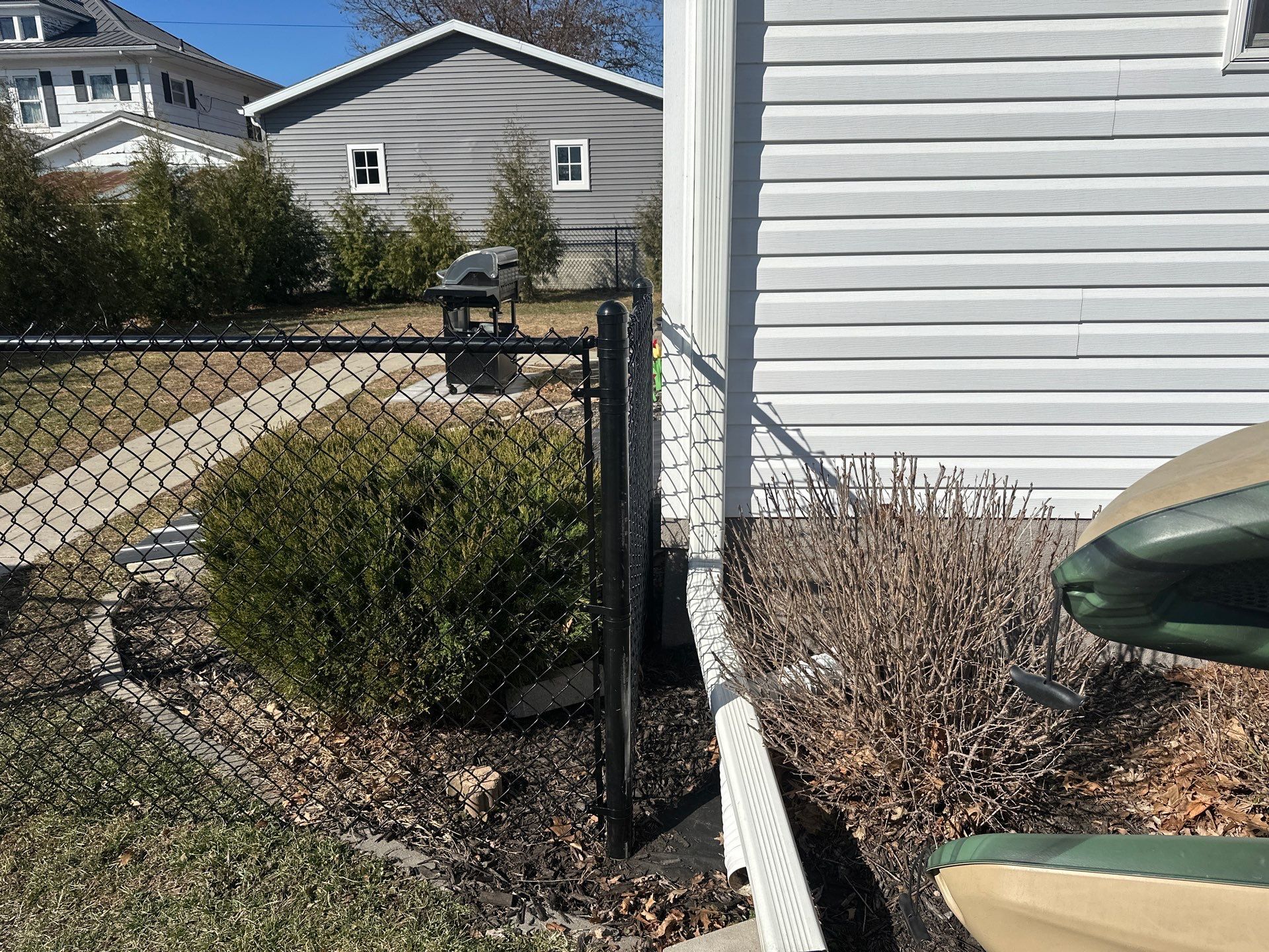 Black Chain Link Backyard Fence Installation in Independence by Perfect Picket Fence and Stain
