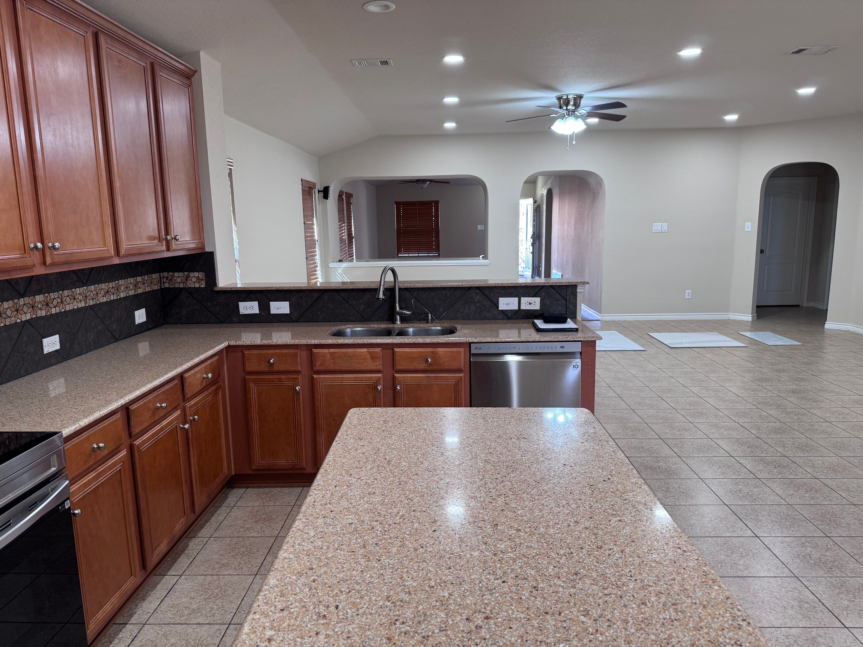 Luxury Focal Point: Full Kitchen Remodel with Double Waterfall Island by Tibi Soli LLC