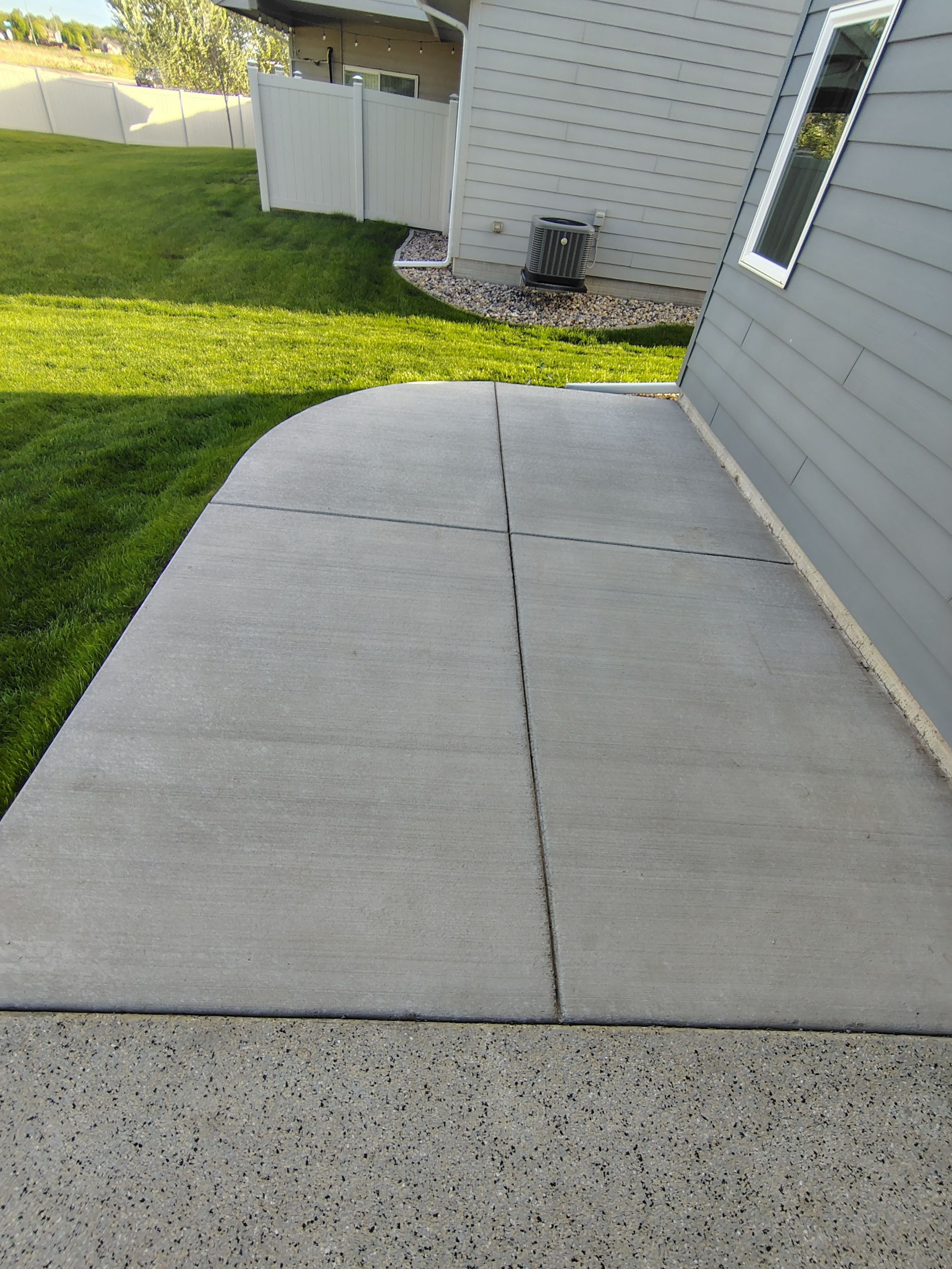 Speckled Concrete Patio Coating Installation in Sioux Falls by Select Painting, Coatings & Garage Cabinets