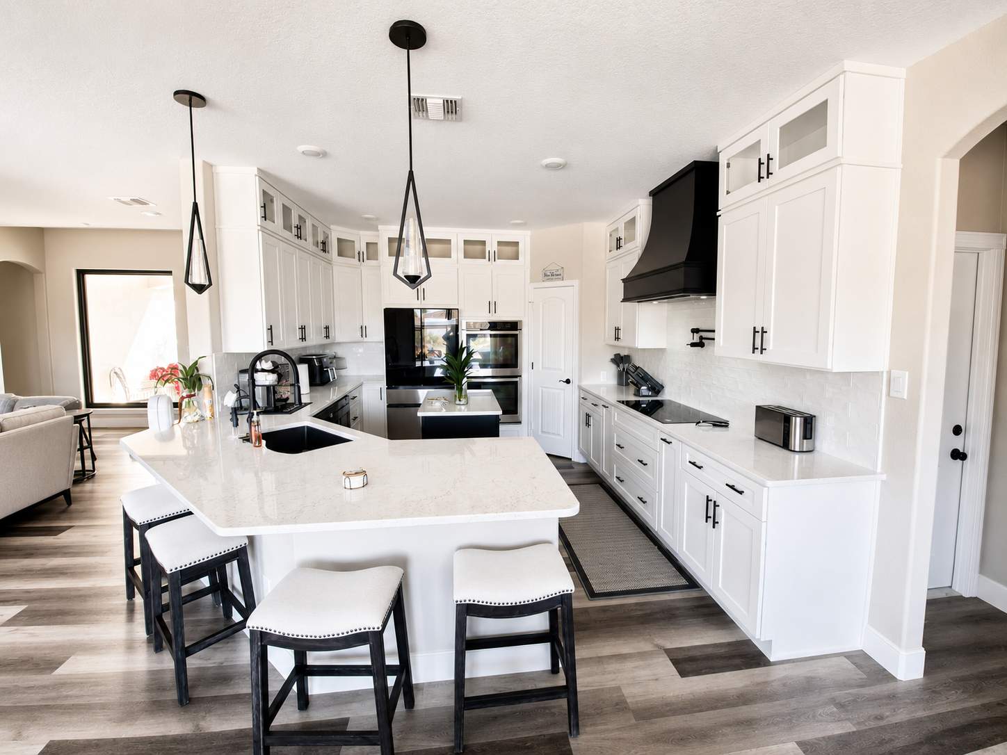 Modern White Kitchen Remodel in San Antonio Featuring Black Range Hood Before and After by Legacy Bath and Kitchen