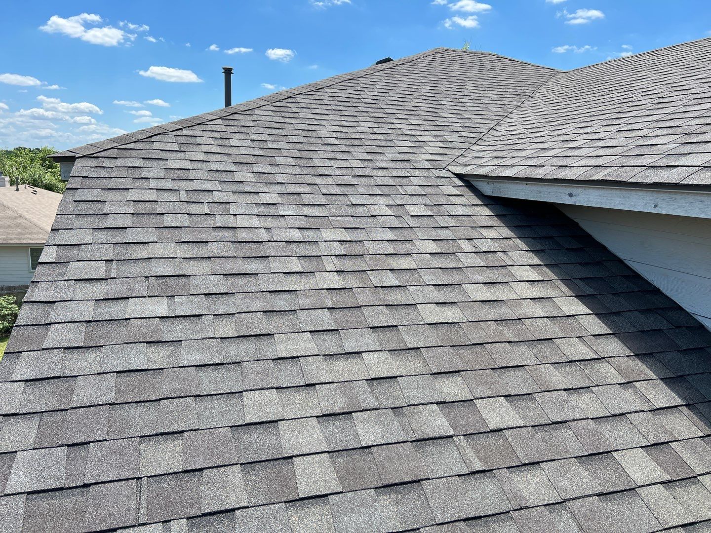 Wind damaged roof replacement by Oakwood Roofing and Construction, LLC