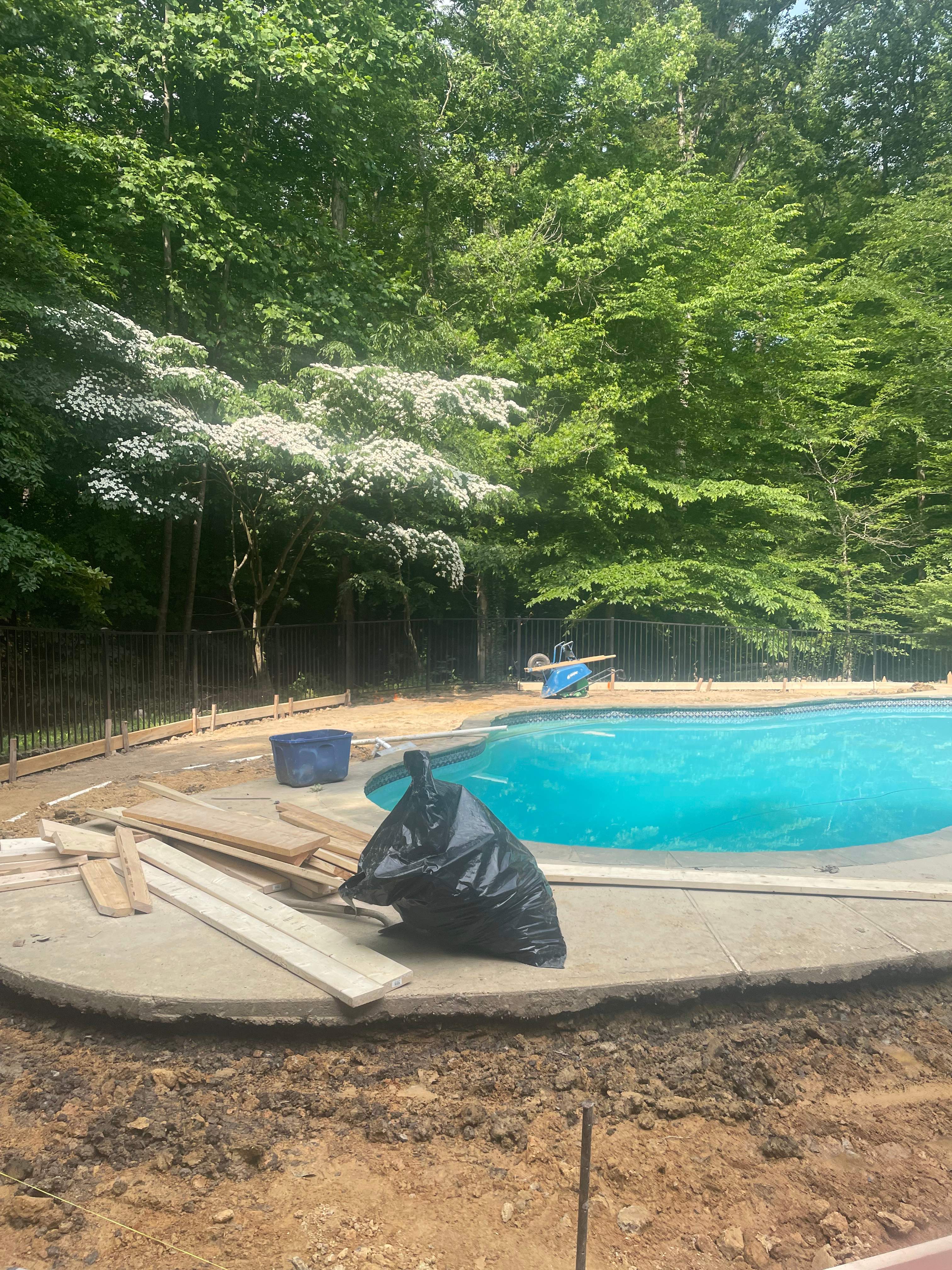 Pool Surround remodel with retaining walls, new waterfall and water slide by Fairfax Contractors, LLC