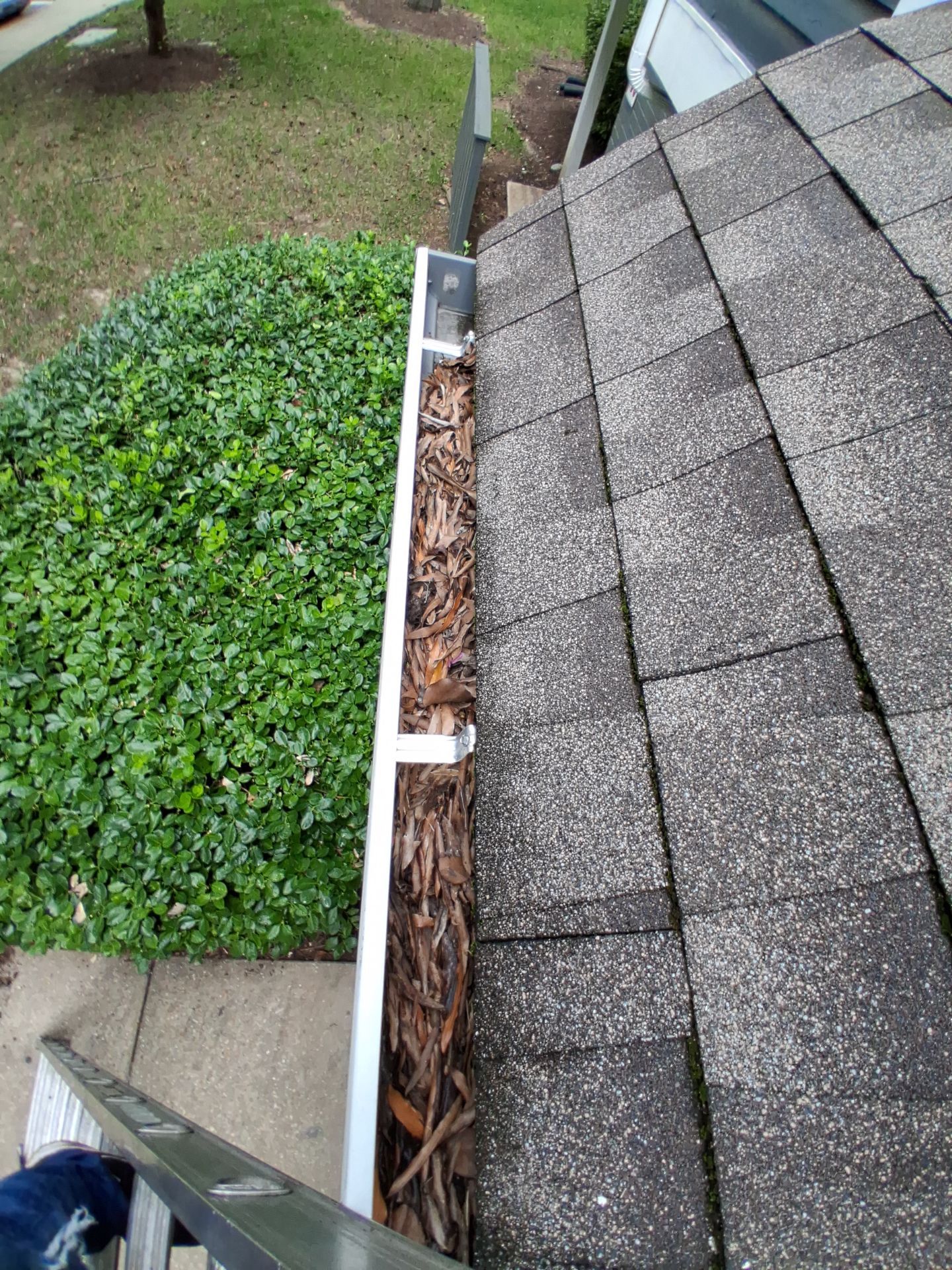 HOA gutter cleaning in Bowie & Largo, MD,before photo showing full gutters.