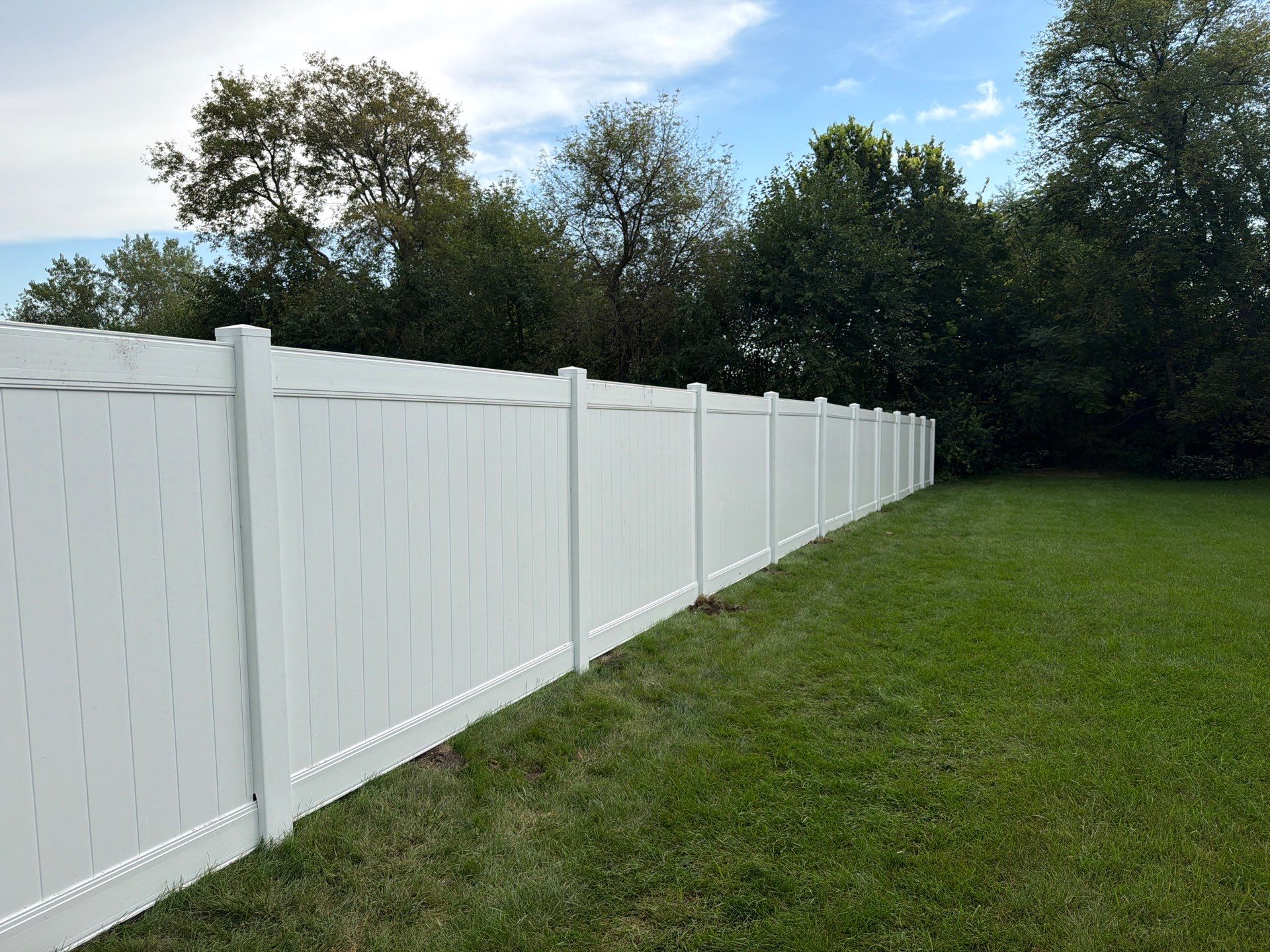 White Vinyl Privacy Fence Installation in Raymond, IA by Perfect Picket Fence and Stain