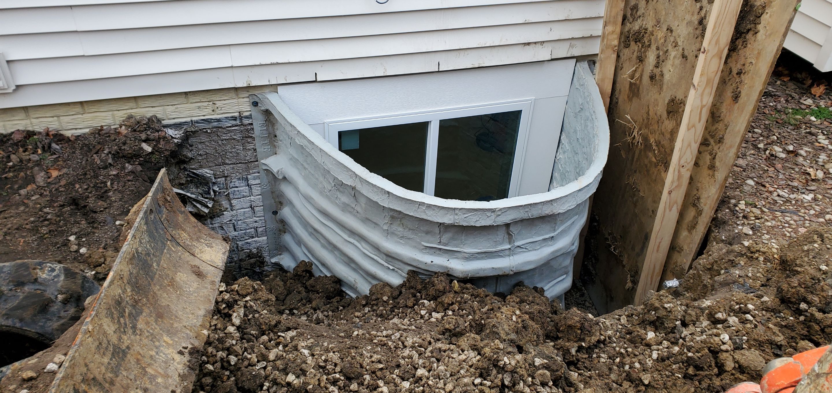 Egress Window Installation using Rockwell Egress Fiberglass Egress Window Well by Toledo Basement Repair 