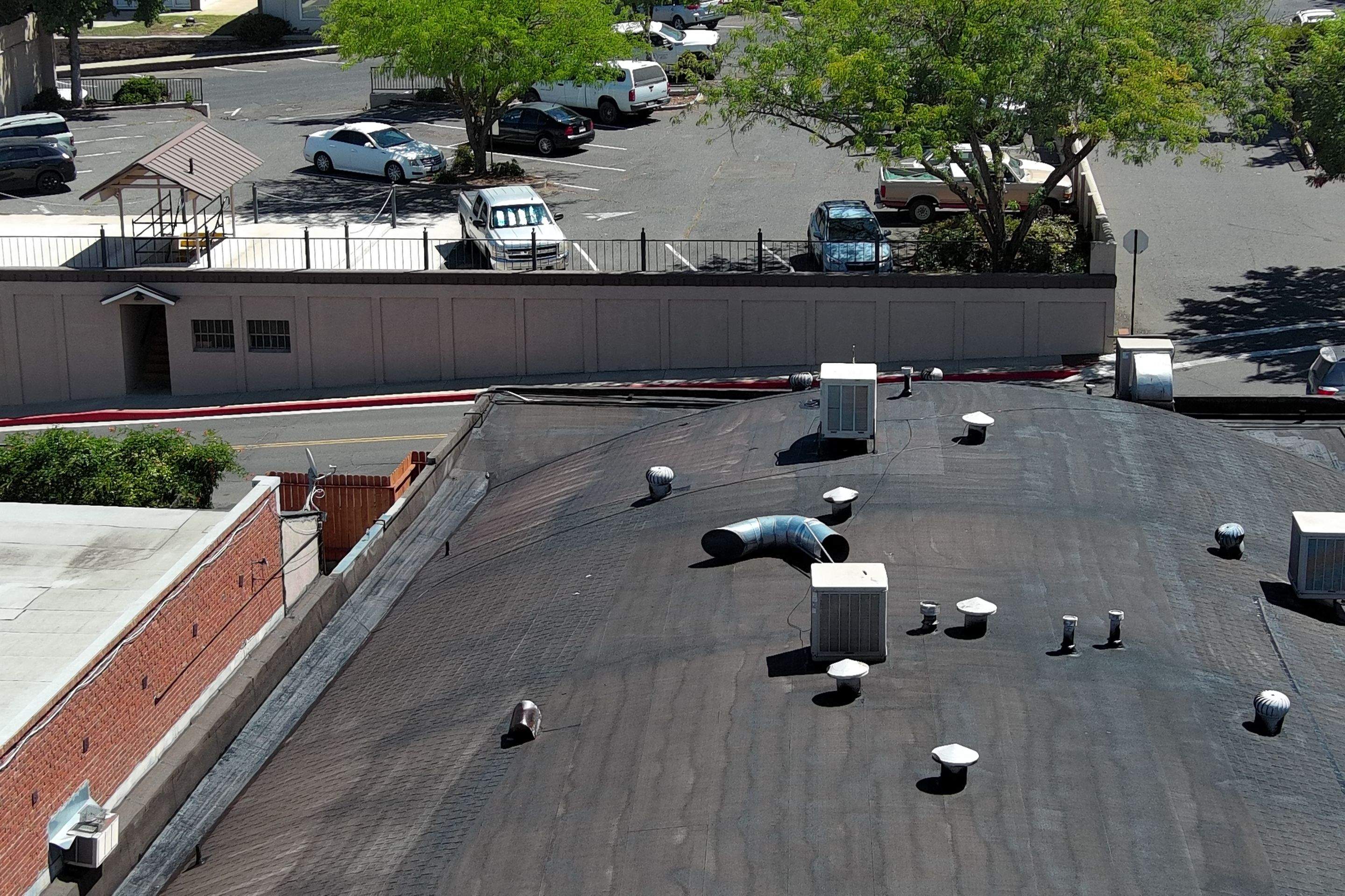 Foam and coatings on commercial roof by Straight Edge Roofing Inc