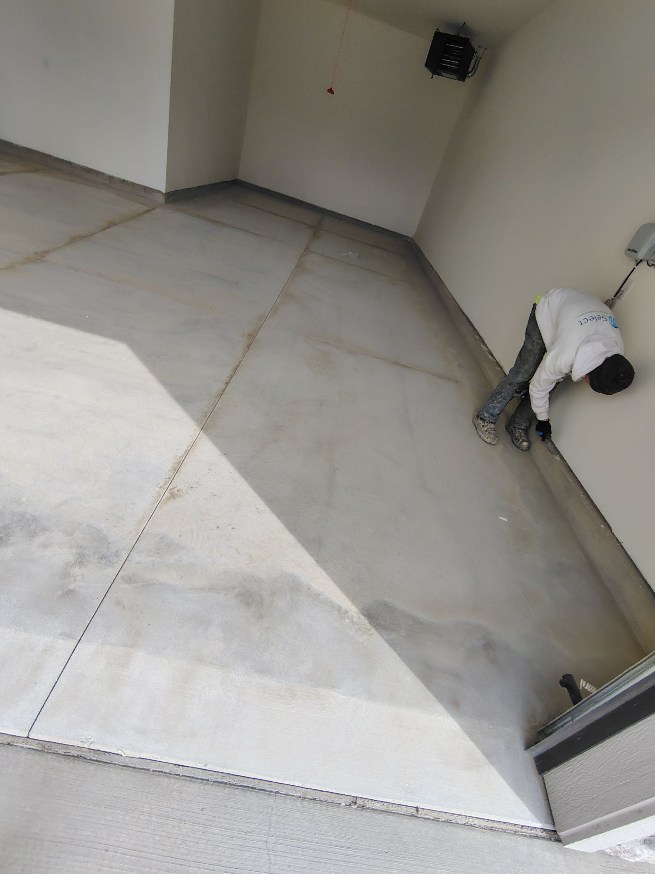 Sioux Falls Garage Floor Transformation with Gray Decorative Flake Coating by Select Painting, Coatings & Garage Cabinets