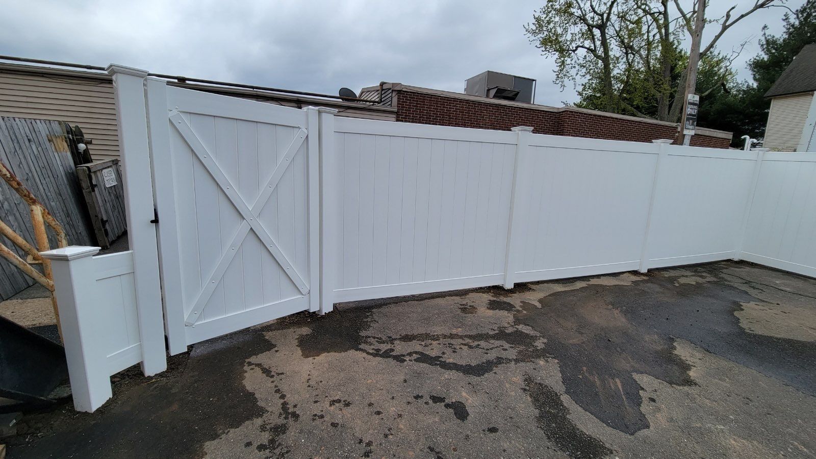 Vinyl Privacy Fence, With matching gate in White  by DiGiorgi Roofing and Siding Inc
