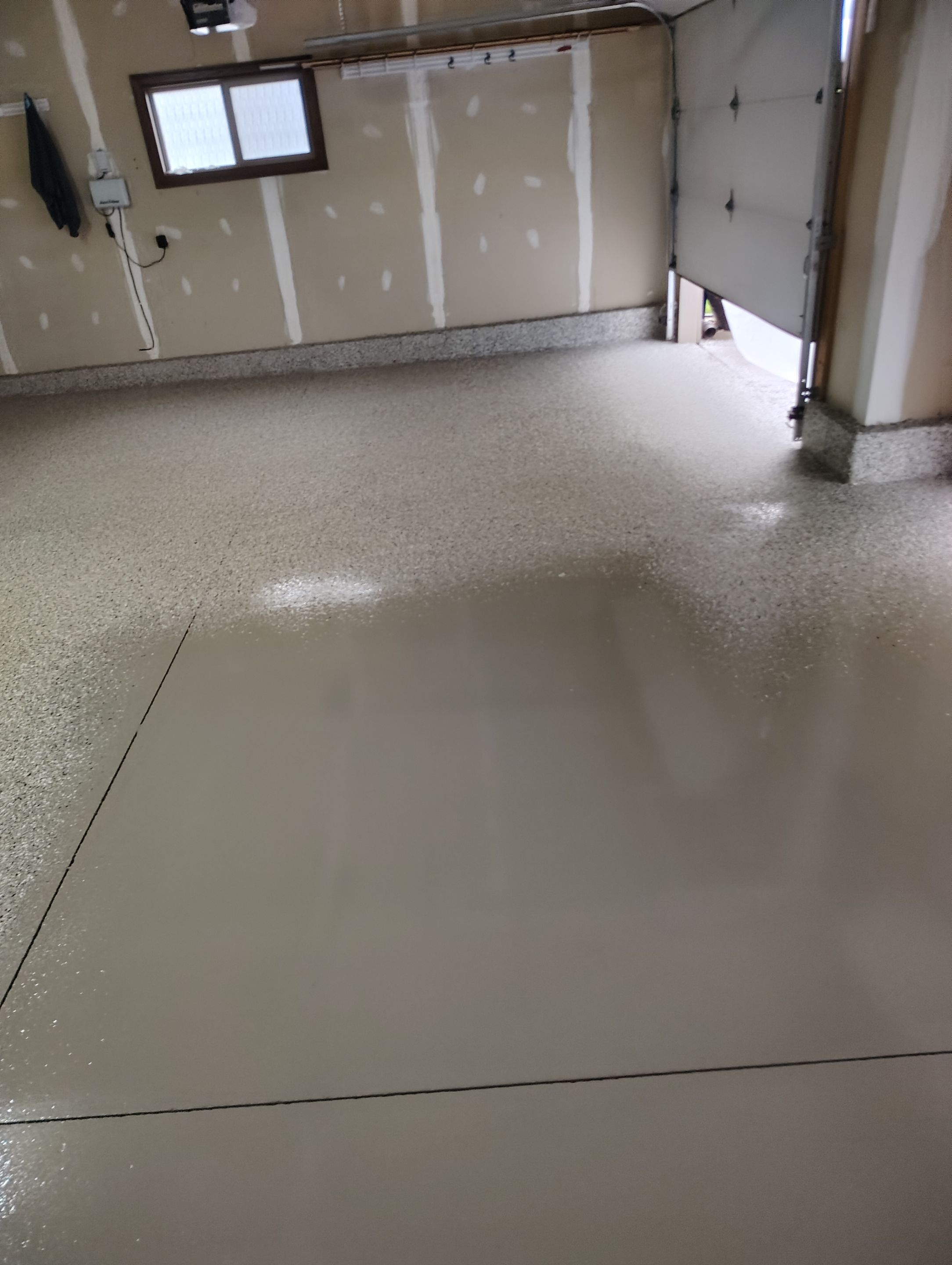 Multi-Car Garage Concrete Coating and Epoxy Finish in Sioux Falls by Select Painting, Coatings & Garage Cabinets