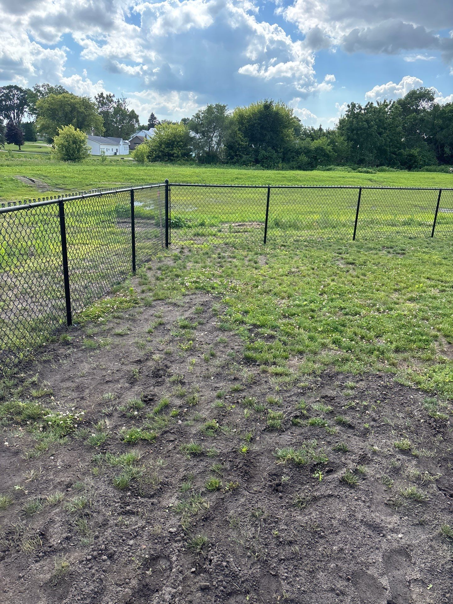 Black Vinyl-Coated Chain Link Fence and Residential Site Grading by Perfect Picket Fence and Stain