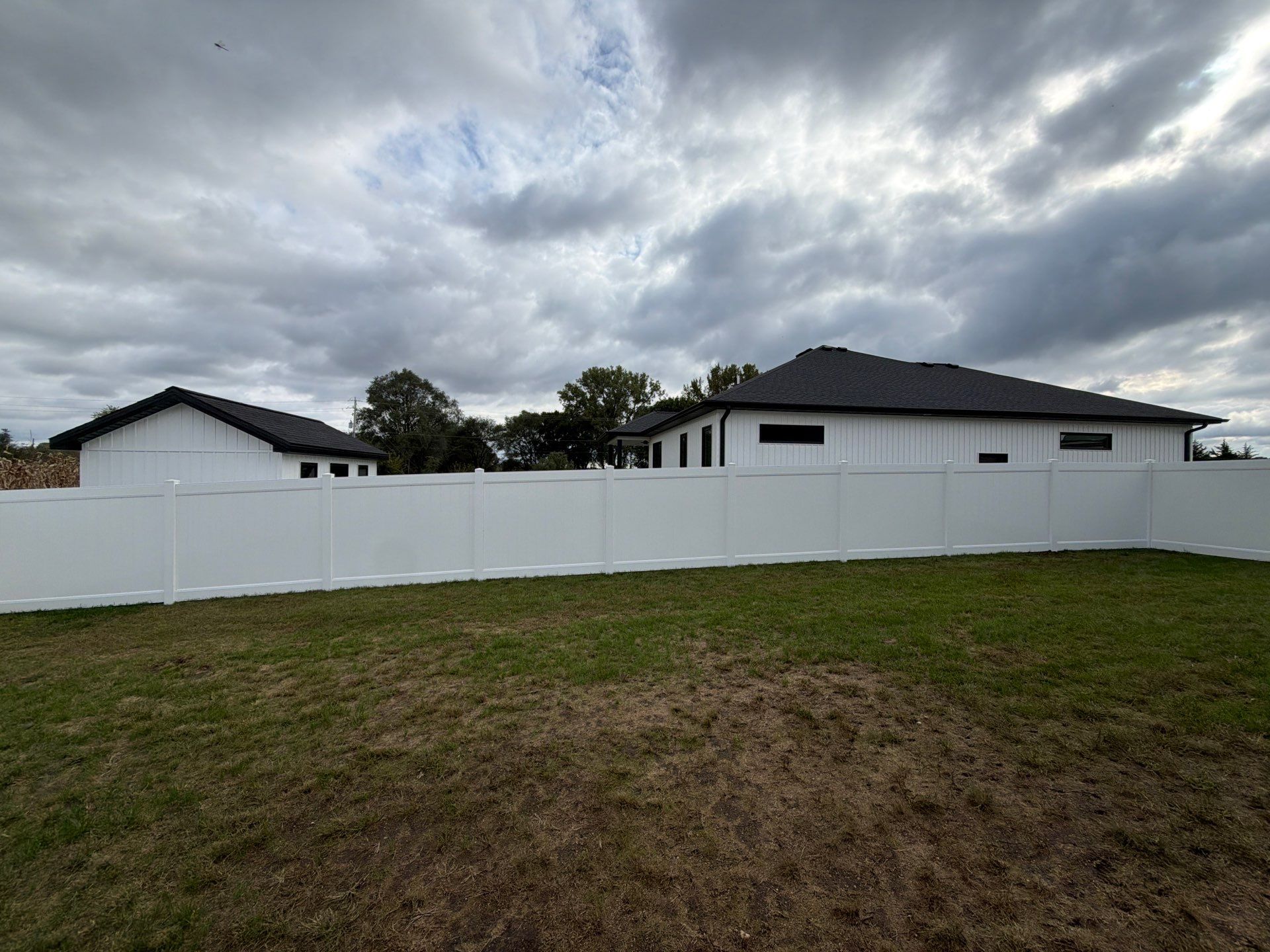 Residential White Vinyl Privacy Fence Installation in Janesville by Perfect Picket Fence and Stain