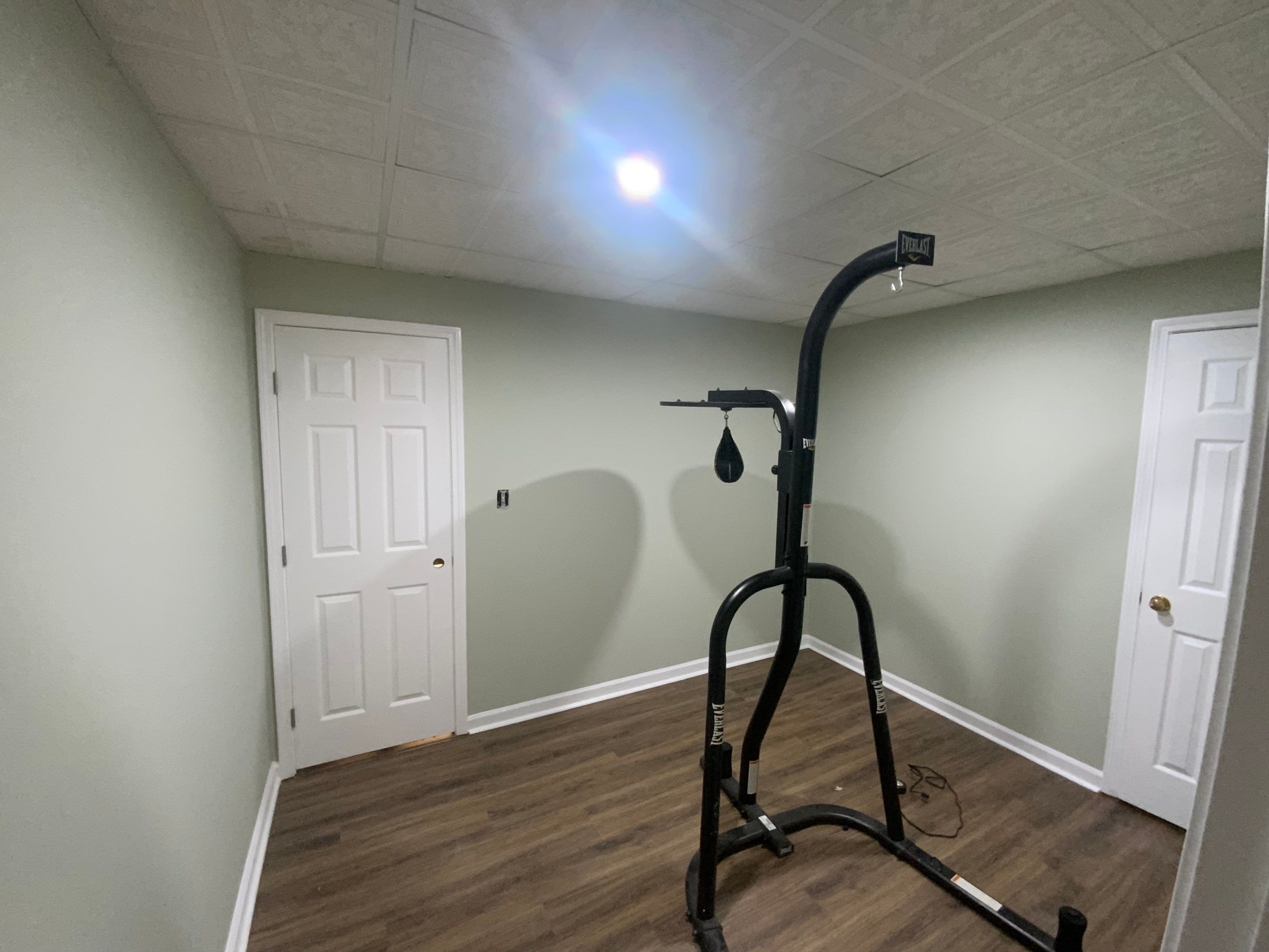 Finished Basement Room Transformation with Wood-Look Flooring in Roswell by Swift Home Renovations