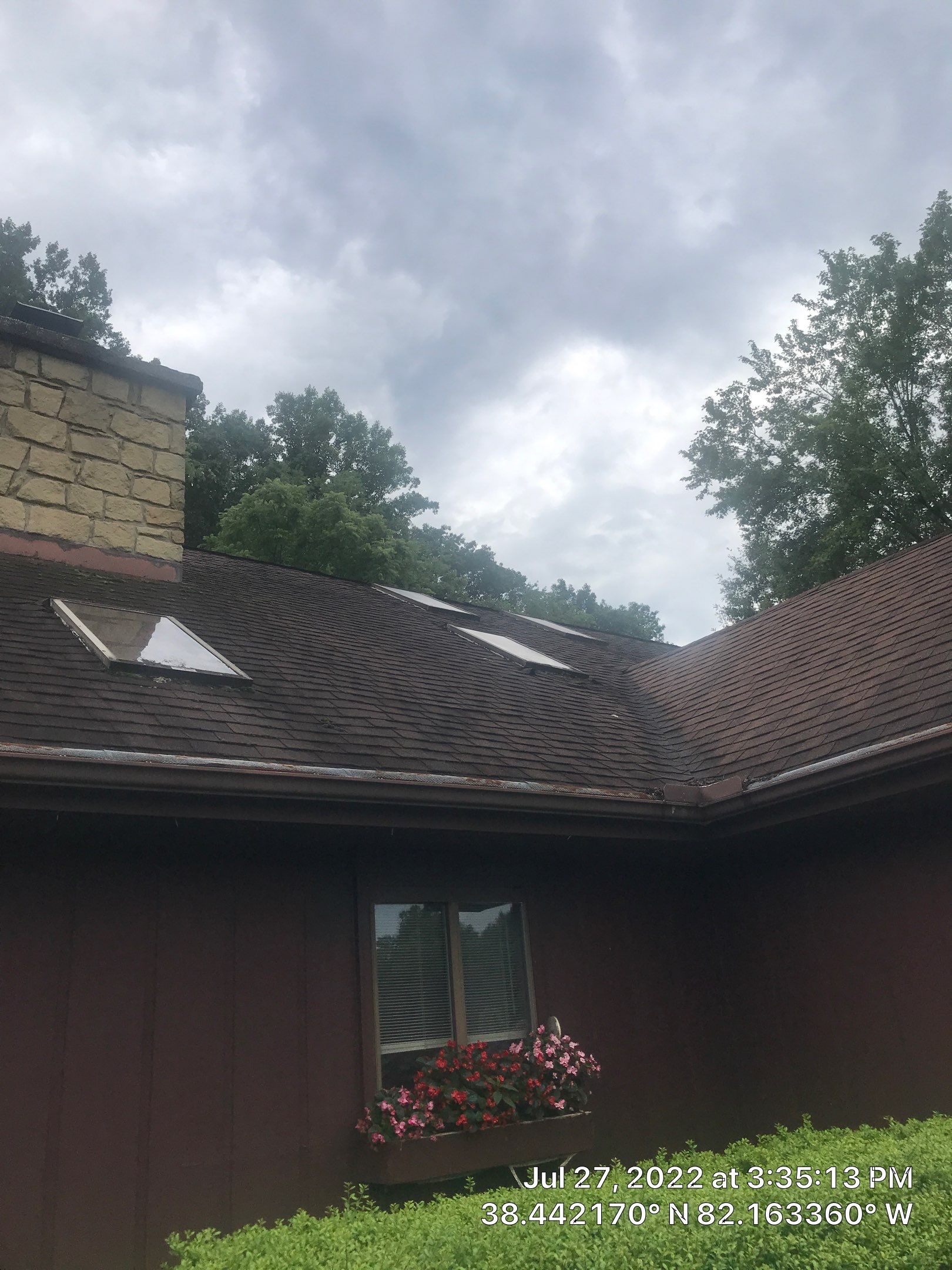 Shingle Roofing with Velux Skylight replacement and stone chimney flashing  by Secure Construction Company Inc