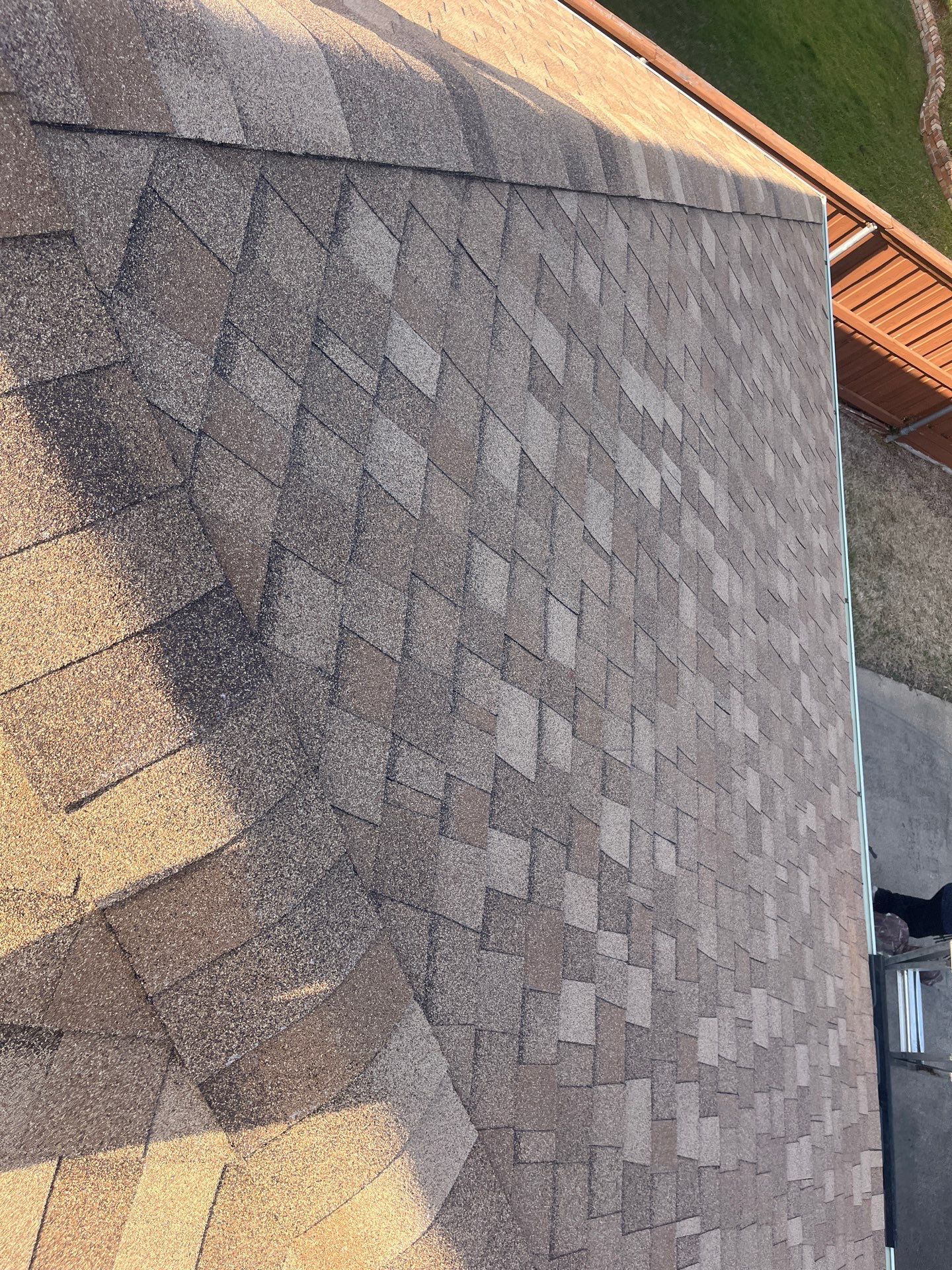 Medium brown brick with Tamko Rustic Cedar by Tejas Roofworks + Restoration