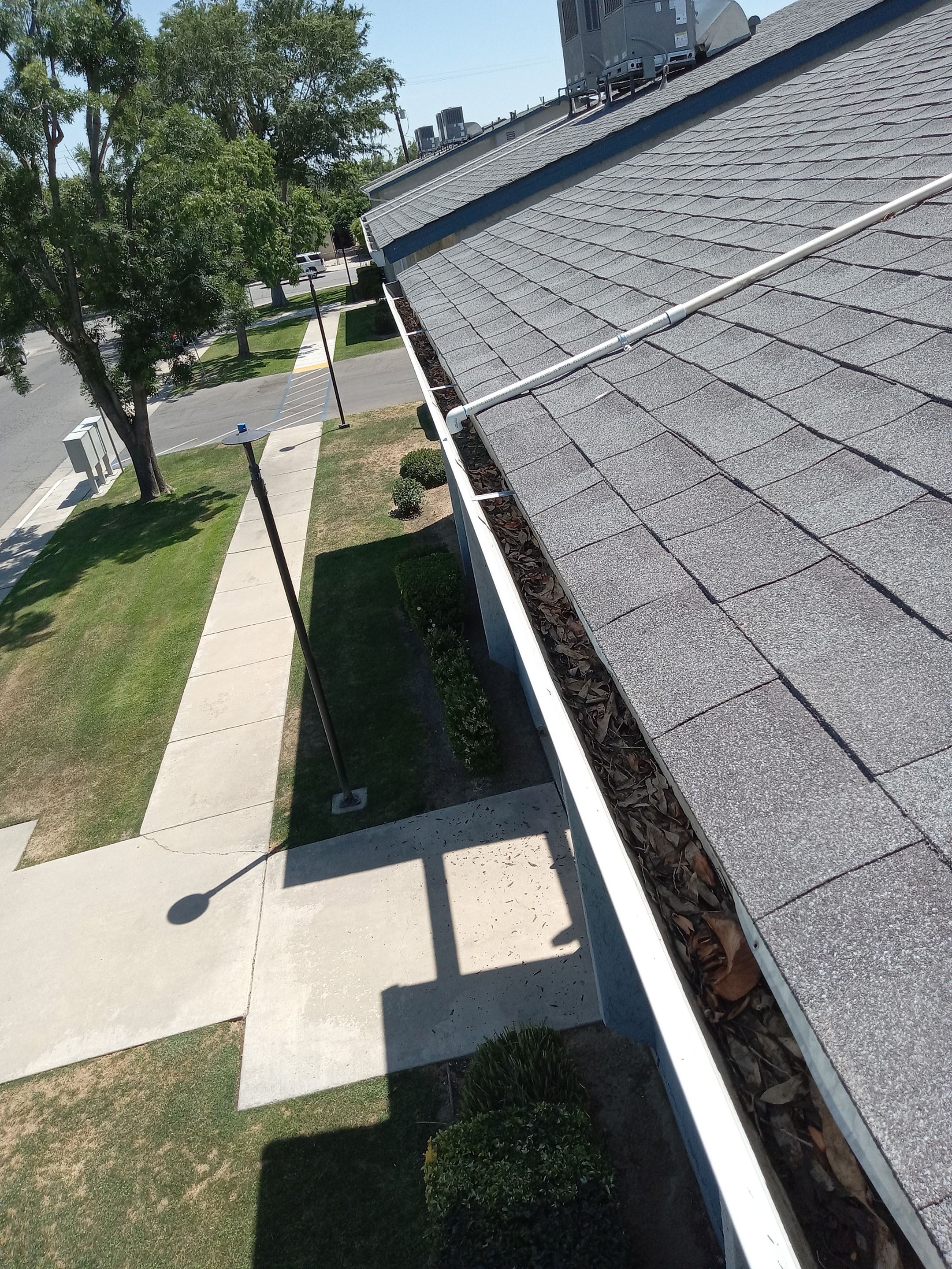 Commercial gutter cleaning Pixley, CA before photo with filled gutters