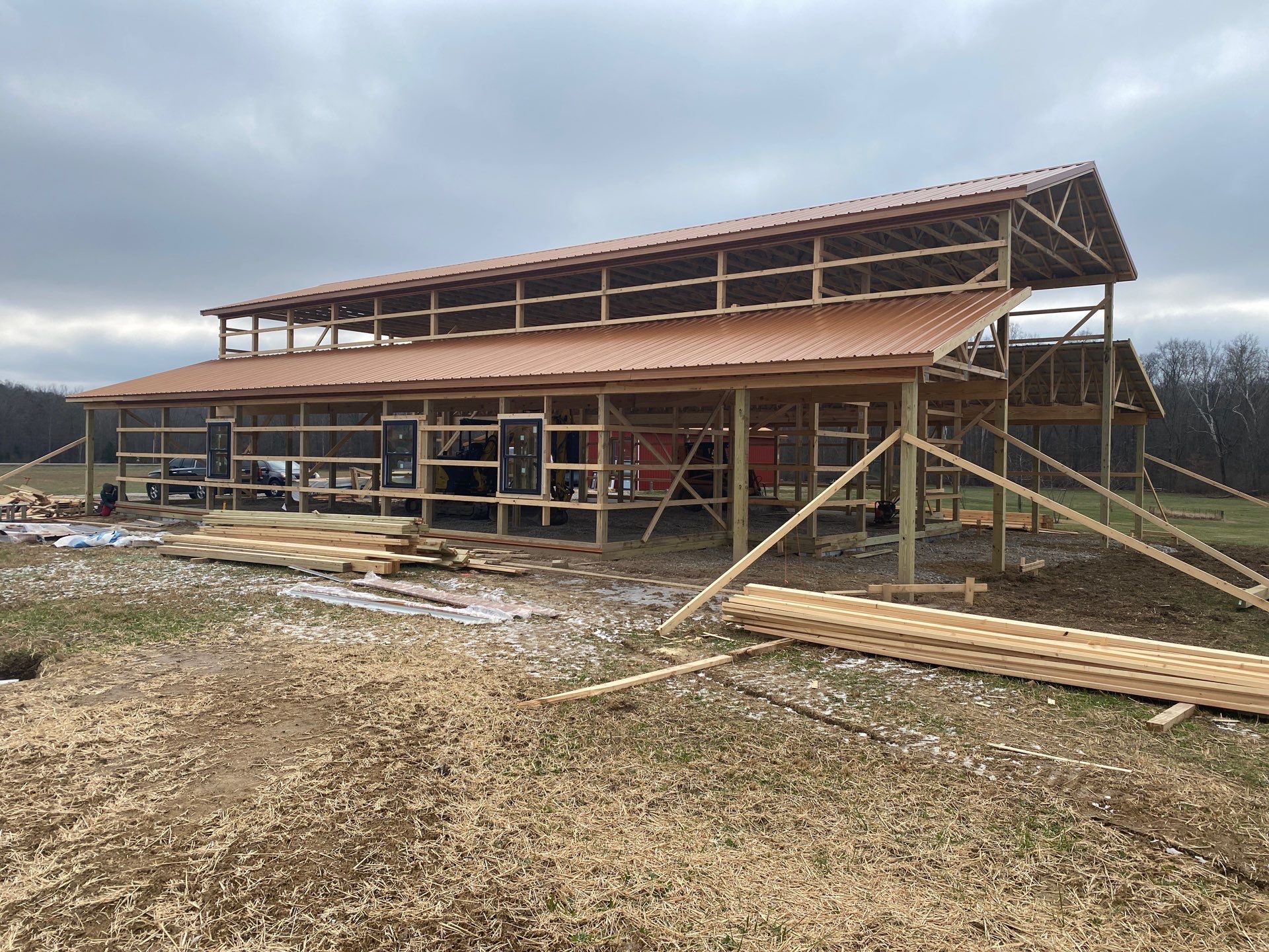Custom Pole Barn Home with Charcoal Siding and Copper Roof by The Barn Builders