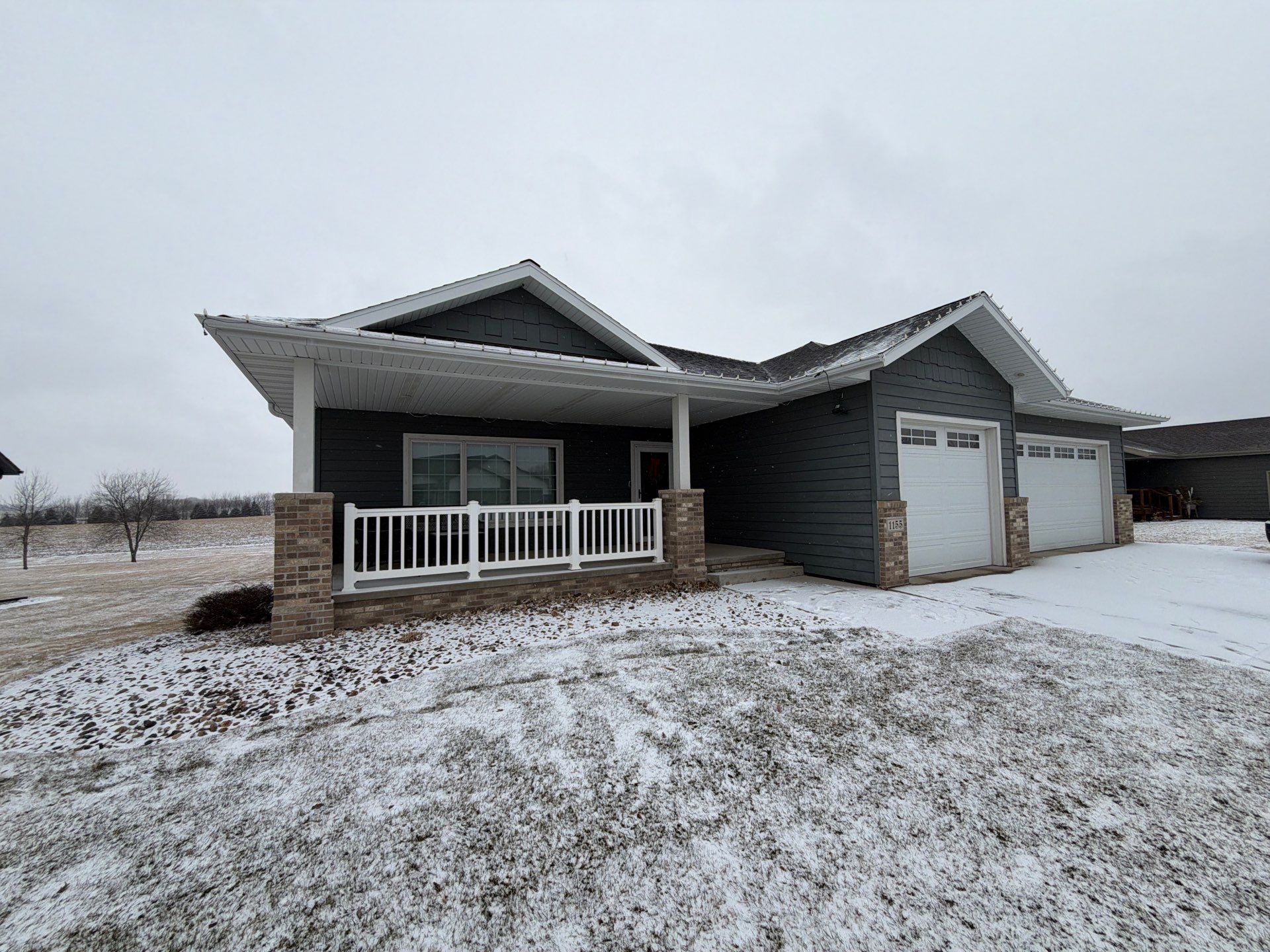 Madison Exterior Remodel with Dark Gray Siding and Stone Accents by Select Painting, Coatings & Garage Cabinets