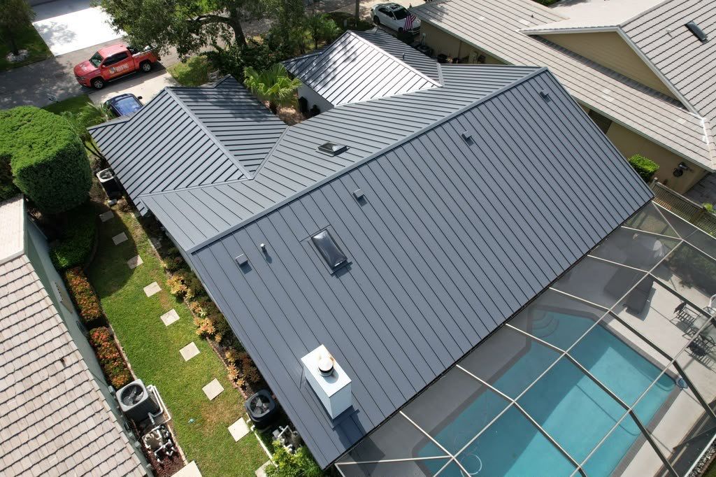 Standing Seam Metal Charcoal Grey Roof Replacement and Skylight Installation in Jupiter by Art's Roofing & Construction