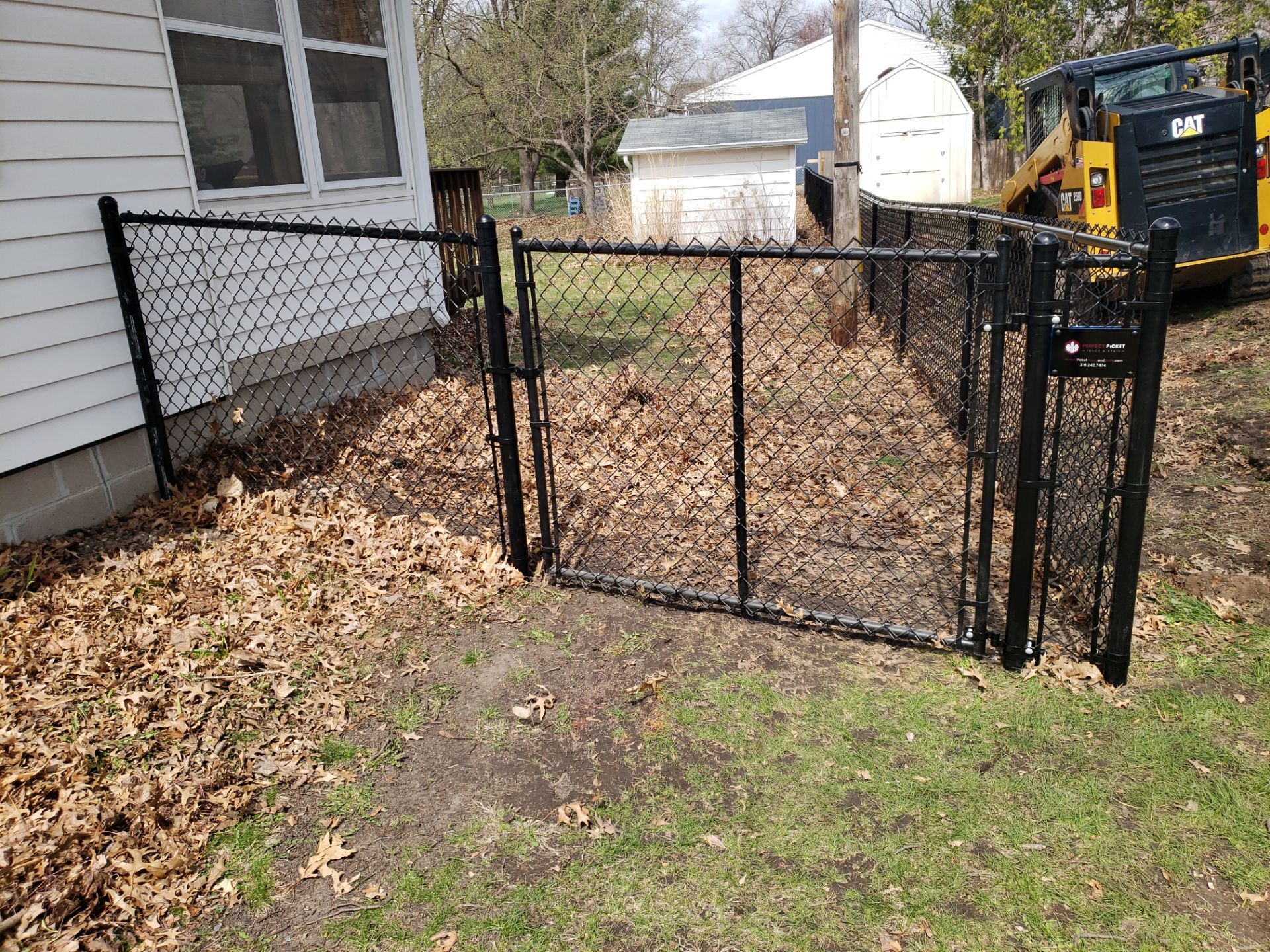 Black Vinyl-Coated Chain Link Fence Installation in Cedar Falls by Perfect Picket Fence and Stain