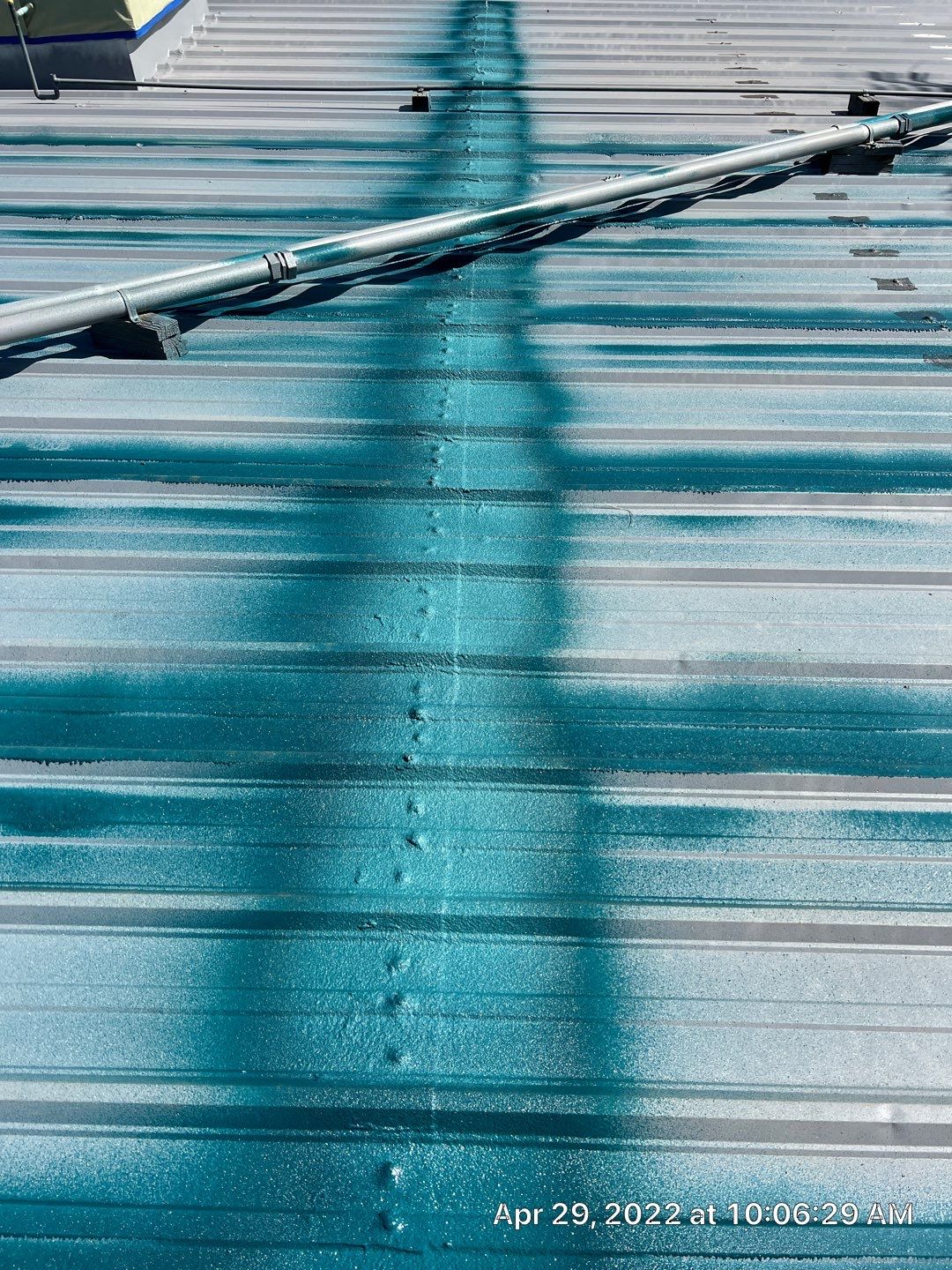 Metal roof restoration on commercial roof using Conklin Benchmark/ PUMA XL acrylic coatings over metal and foam by Straight Edge Roofing Inc