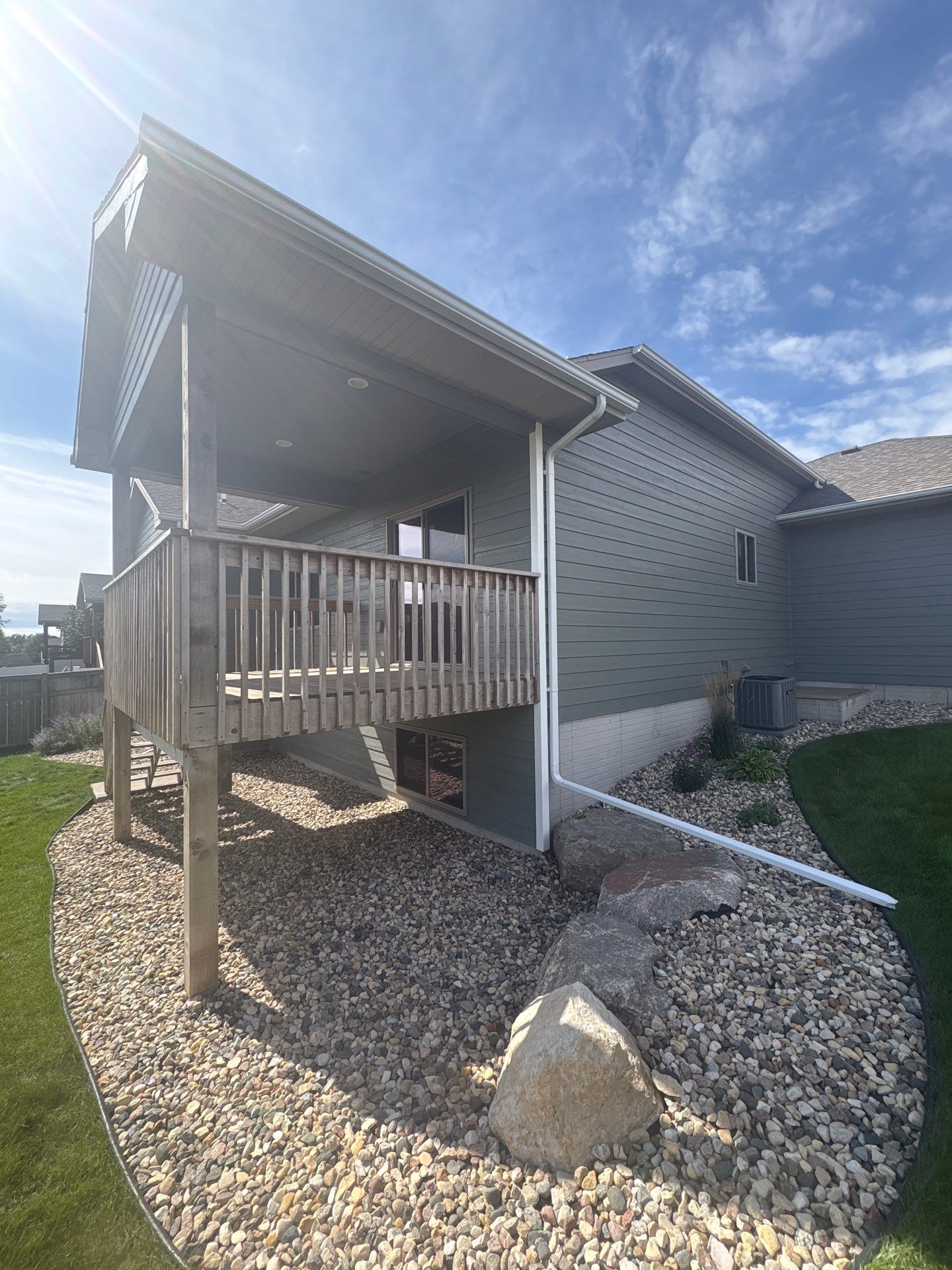 Full Exterior Home Painting on Blue Lap Siding in Sioux Falls by Select Painting, Coatings & Garage Cabinets