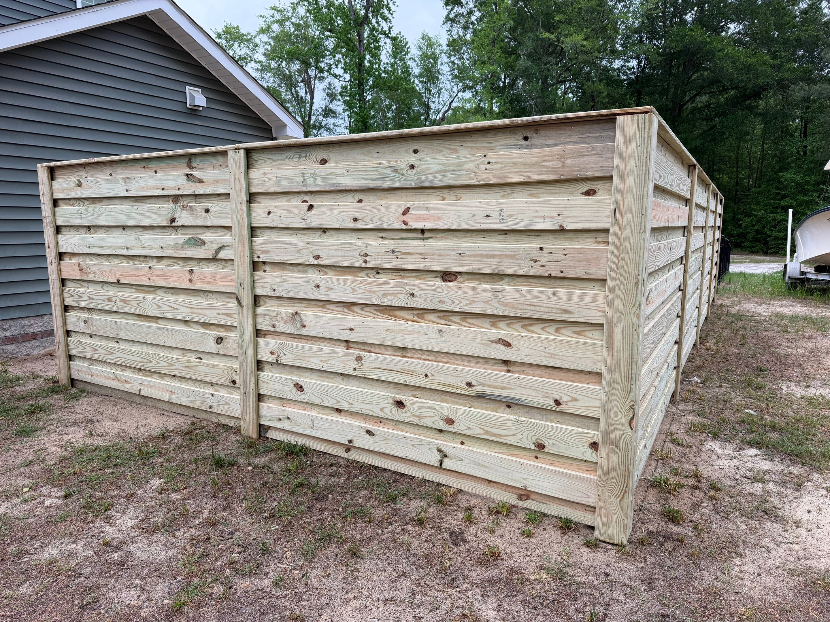 Modern Horizontal Wood Privacy Fence and Backyard Patio in Greenville by Superior Fence and Rail