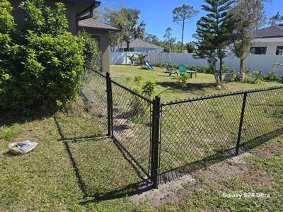 Residential Black Vinyl-Coated Chain Link Fence Installation in North Port