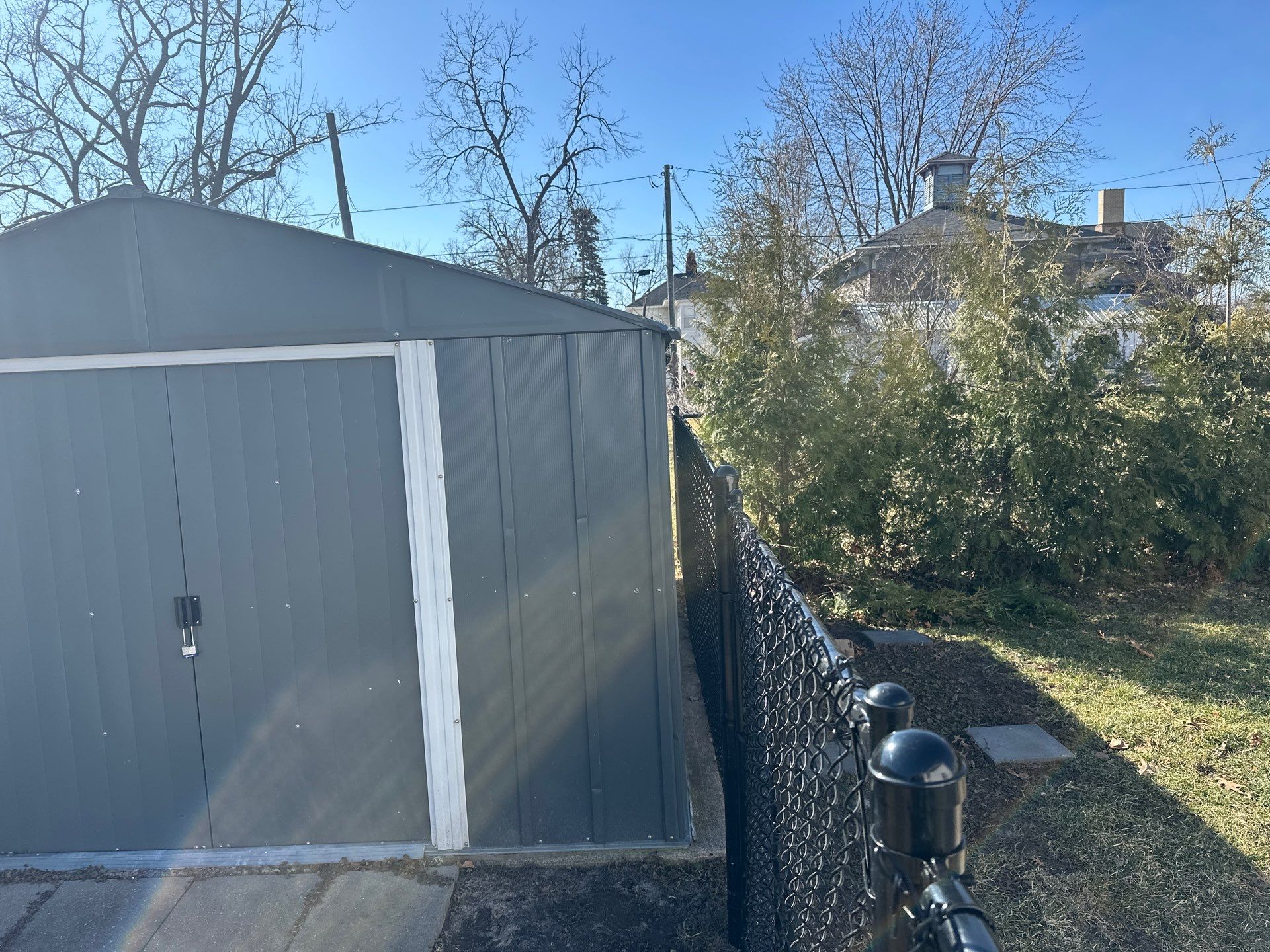 Black Chain Link Backyard Fence Installation in Independence by Perfect Picket Fence and Stain