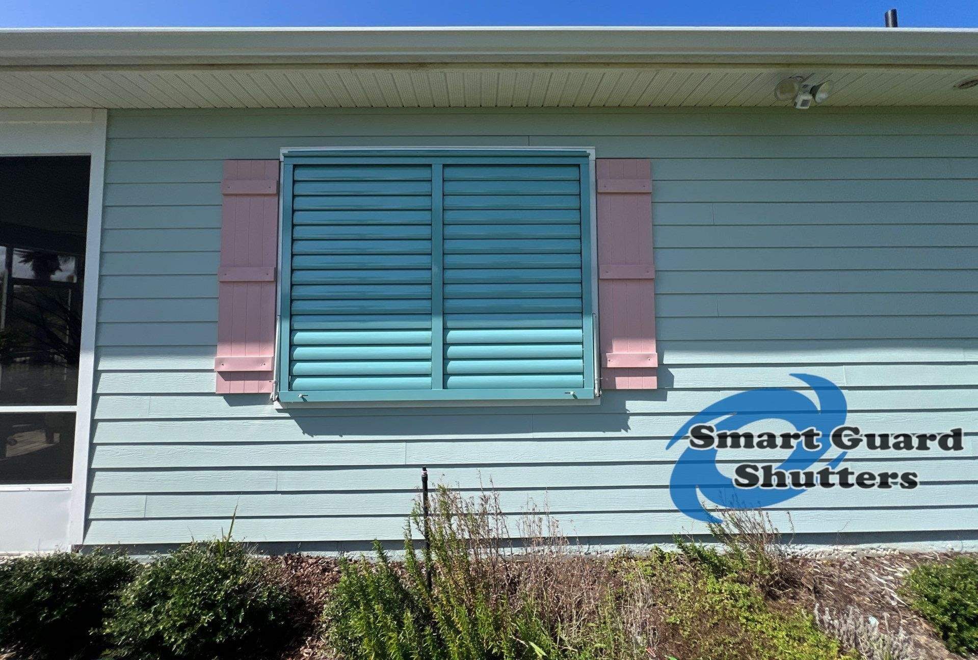Impact Bahama Shutters in Pastel Turquoise by Smart Guard Shutters