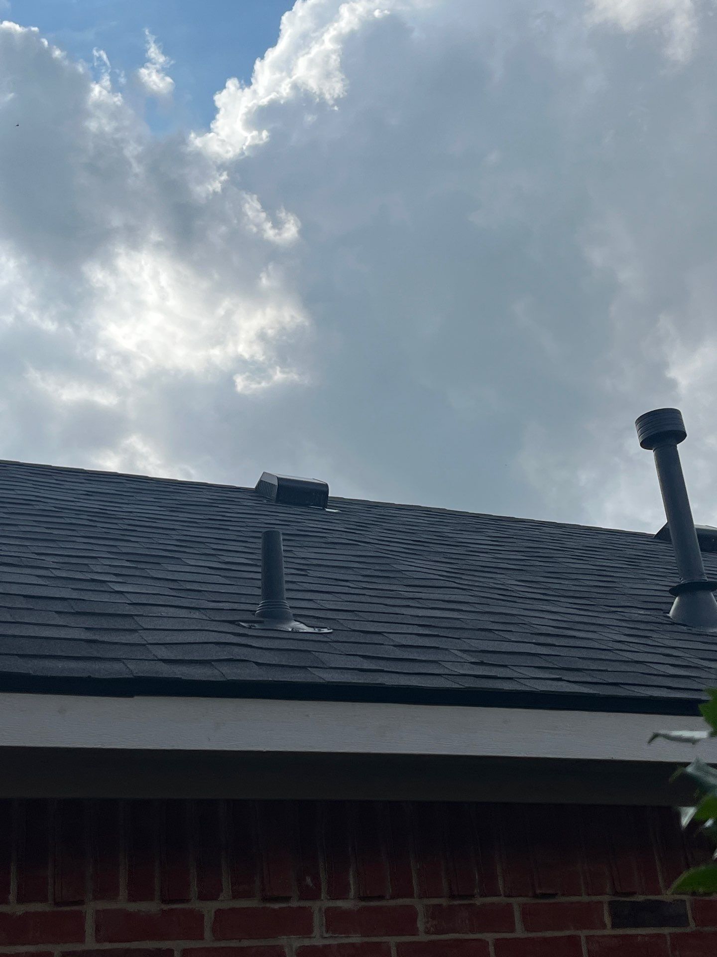Red brick with Malarkey Midnight Black  by Tejas Roofworks + Restoration