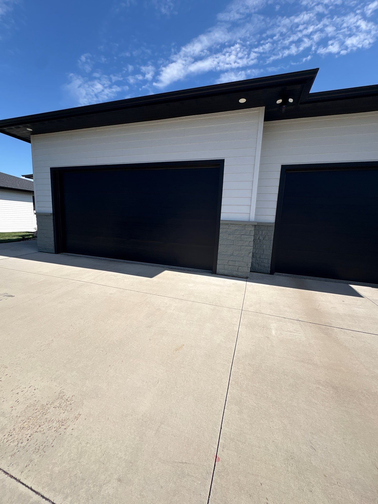 Modern Exterior Update with Siding and Stone Masonry in Sioux Falls by Select Painting, Coatings & Garage Cabinets